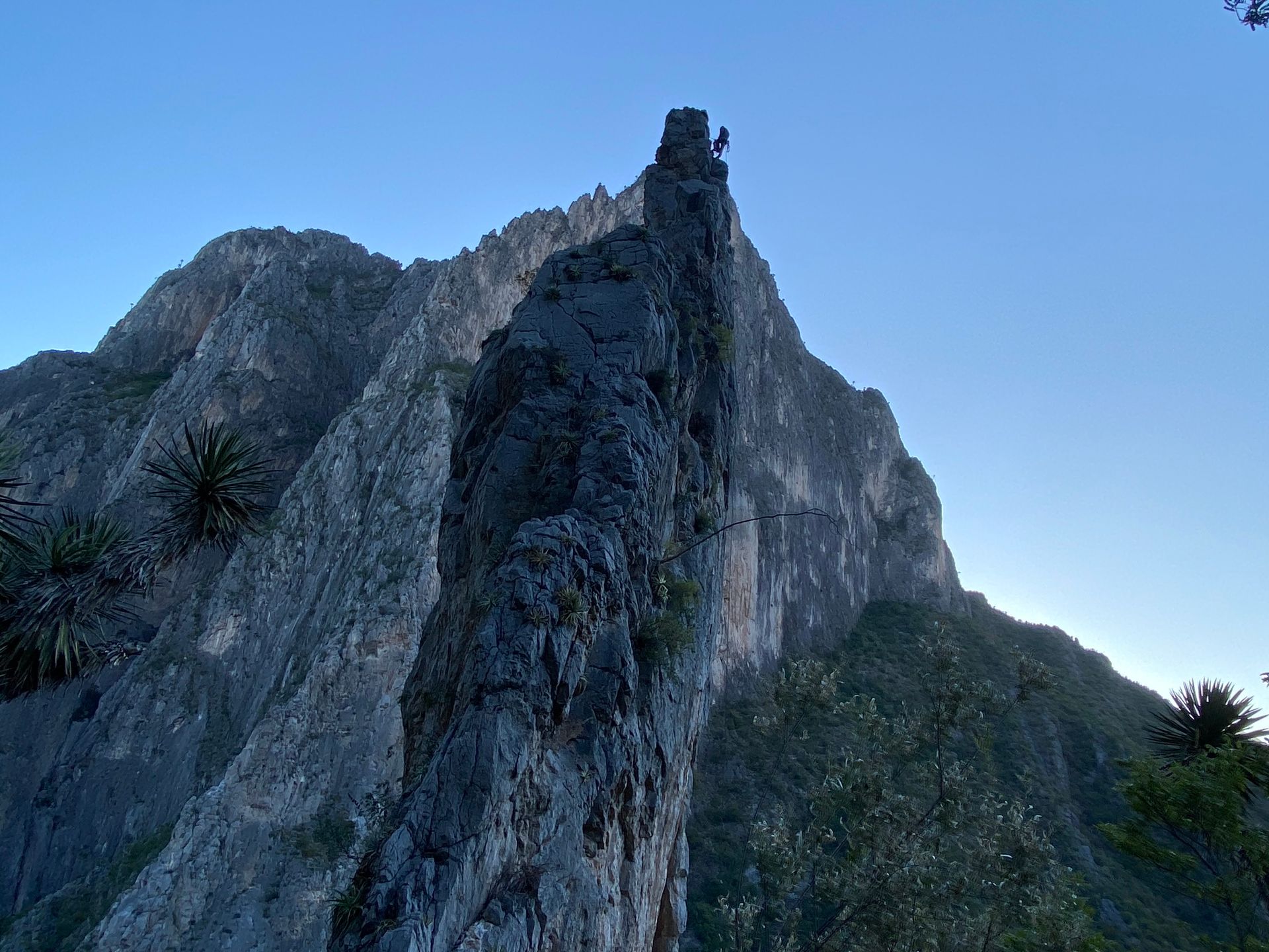 A person is standing on top of a rocky mountain