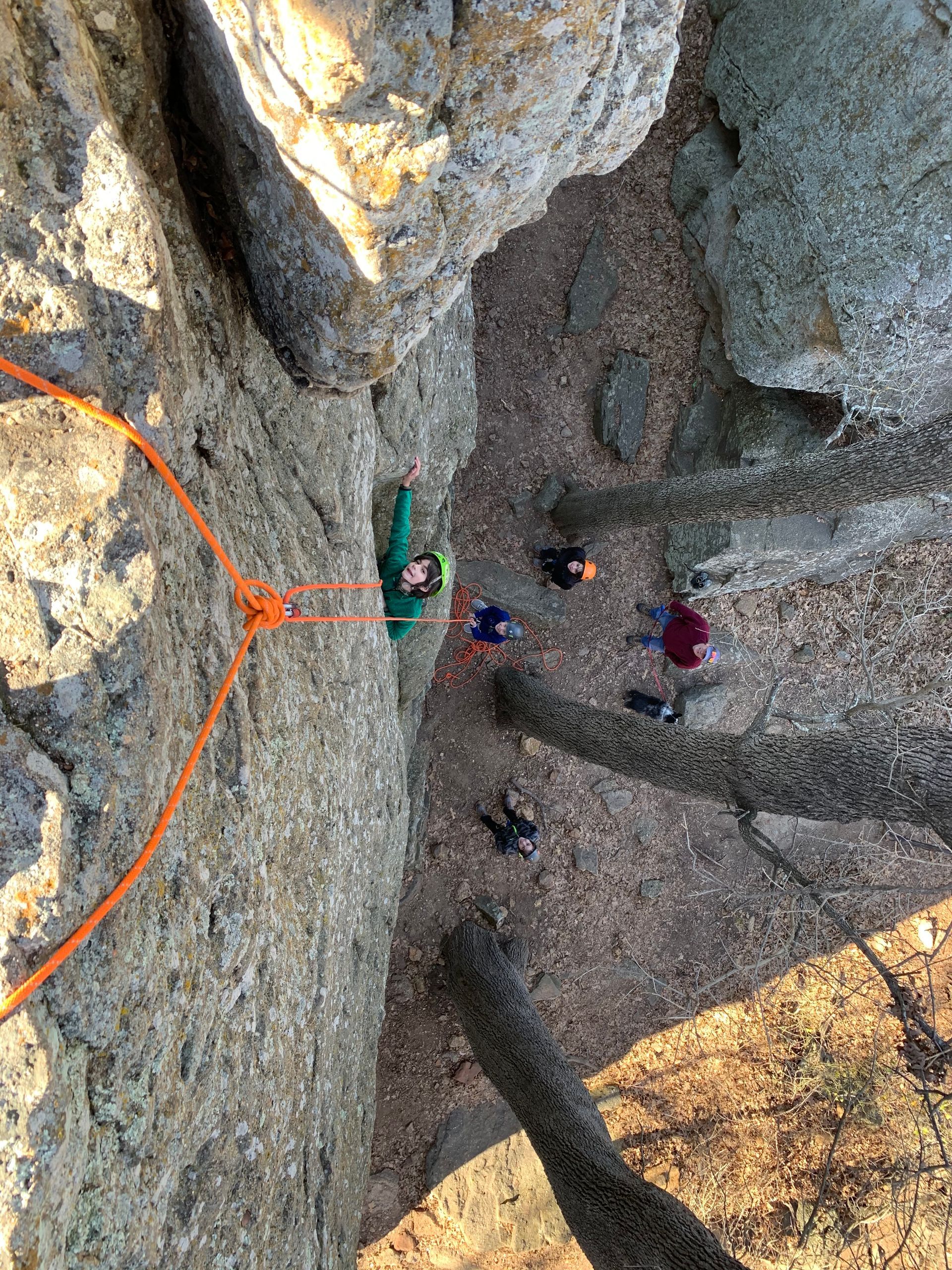 A group of people are climbing up a rock wall.