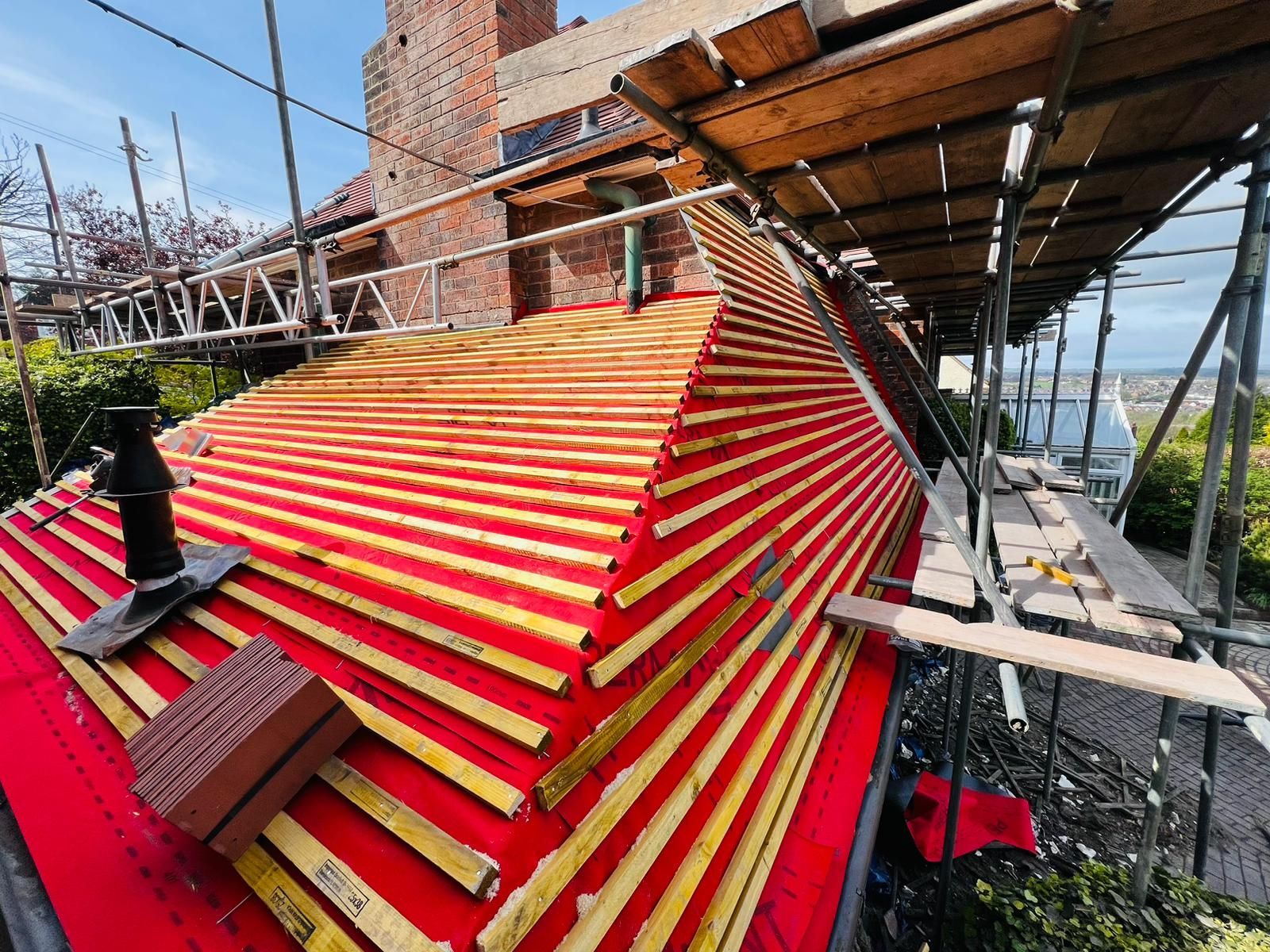 A man is working on the roof of a building.