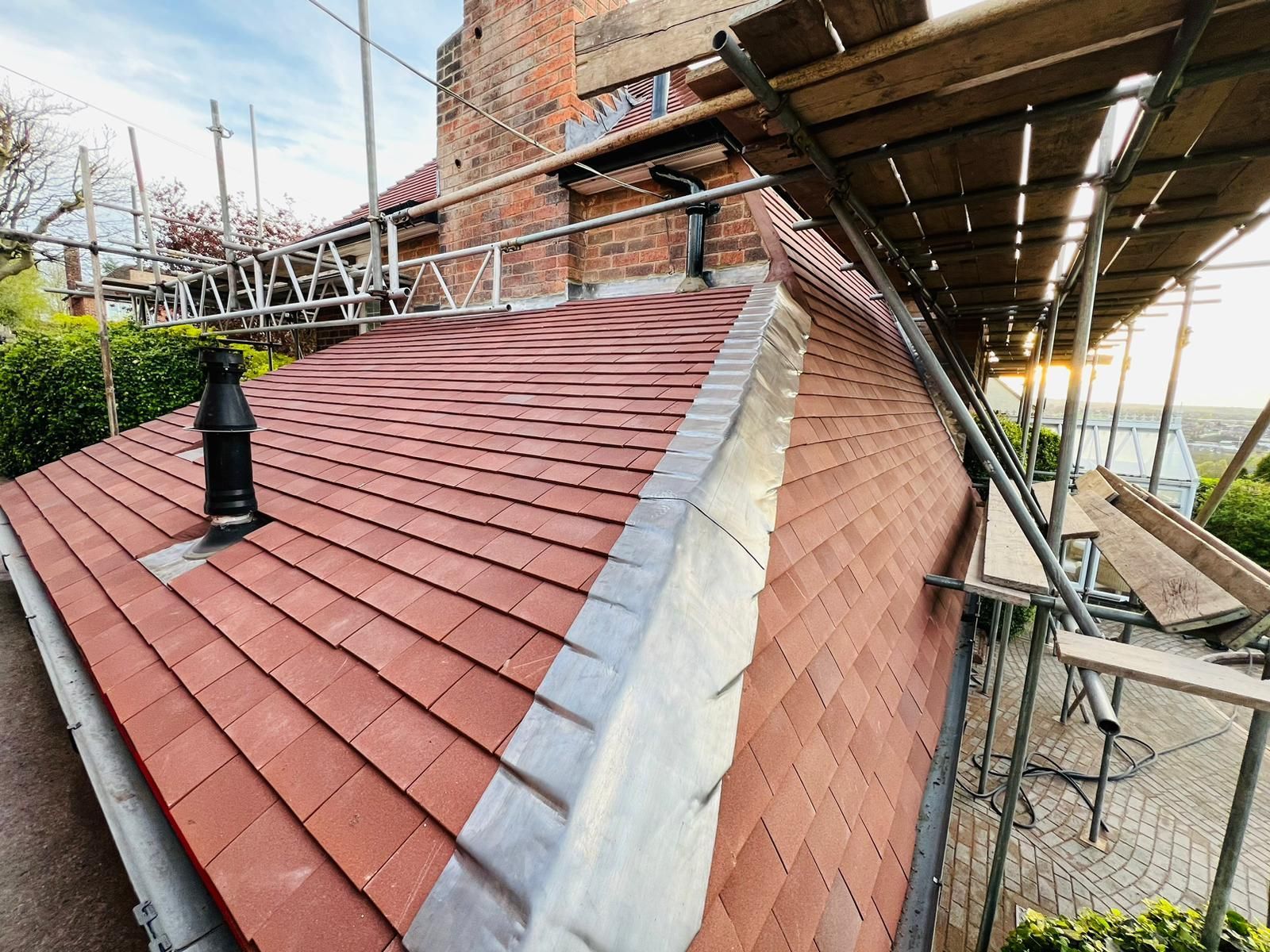 A man is working on the roof of a building.