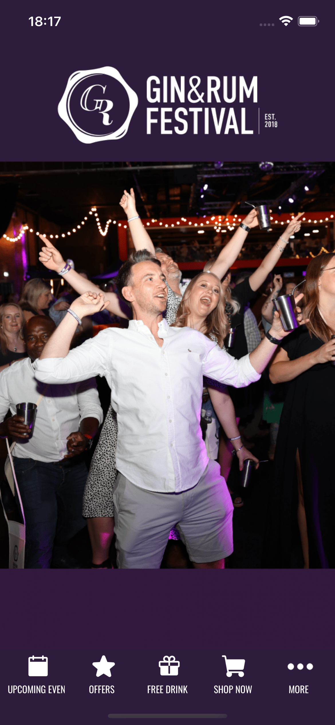 A group of people are dancing at a gin and rum festival.