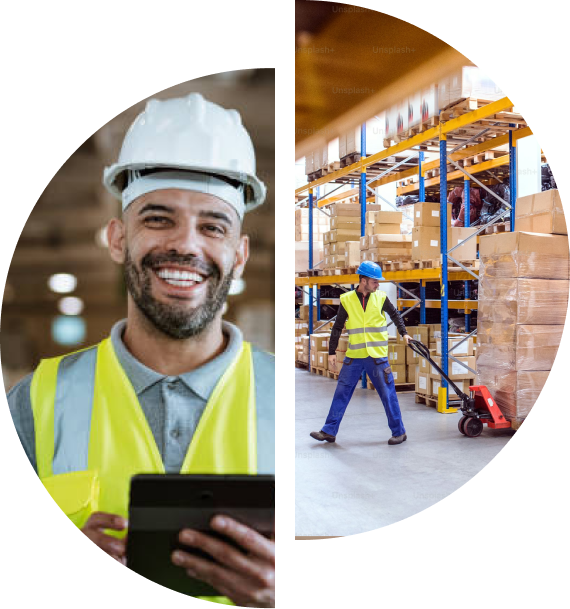 Warehouse workers; man smiling, wearing hard hat and vest, holding tablet. Another worker moves boxes with a pallet jack.