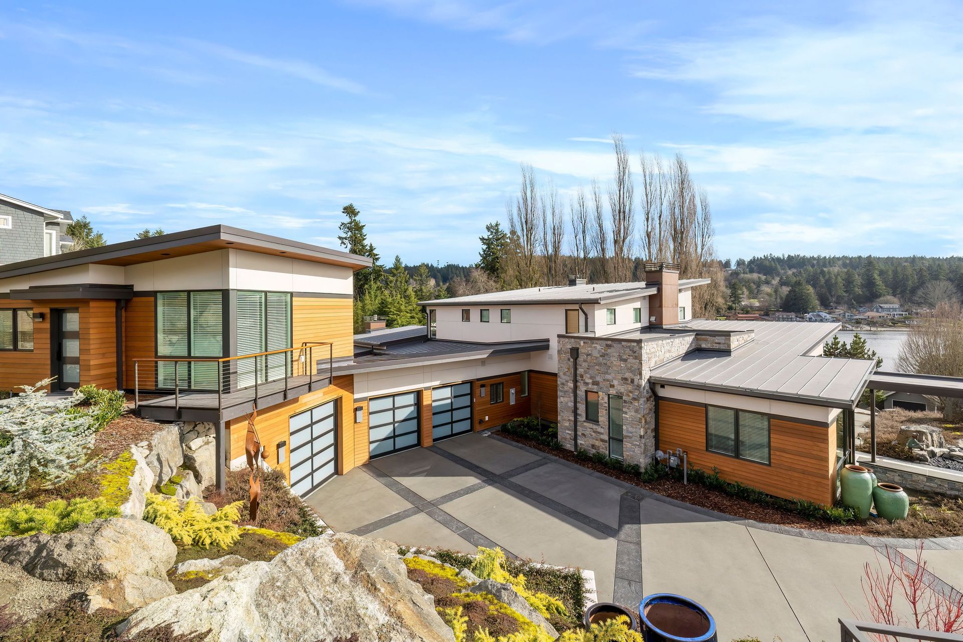 A large house with a lot of windows and a large driveway.