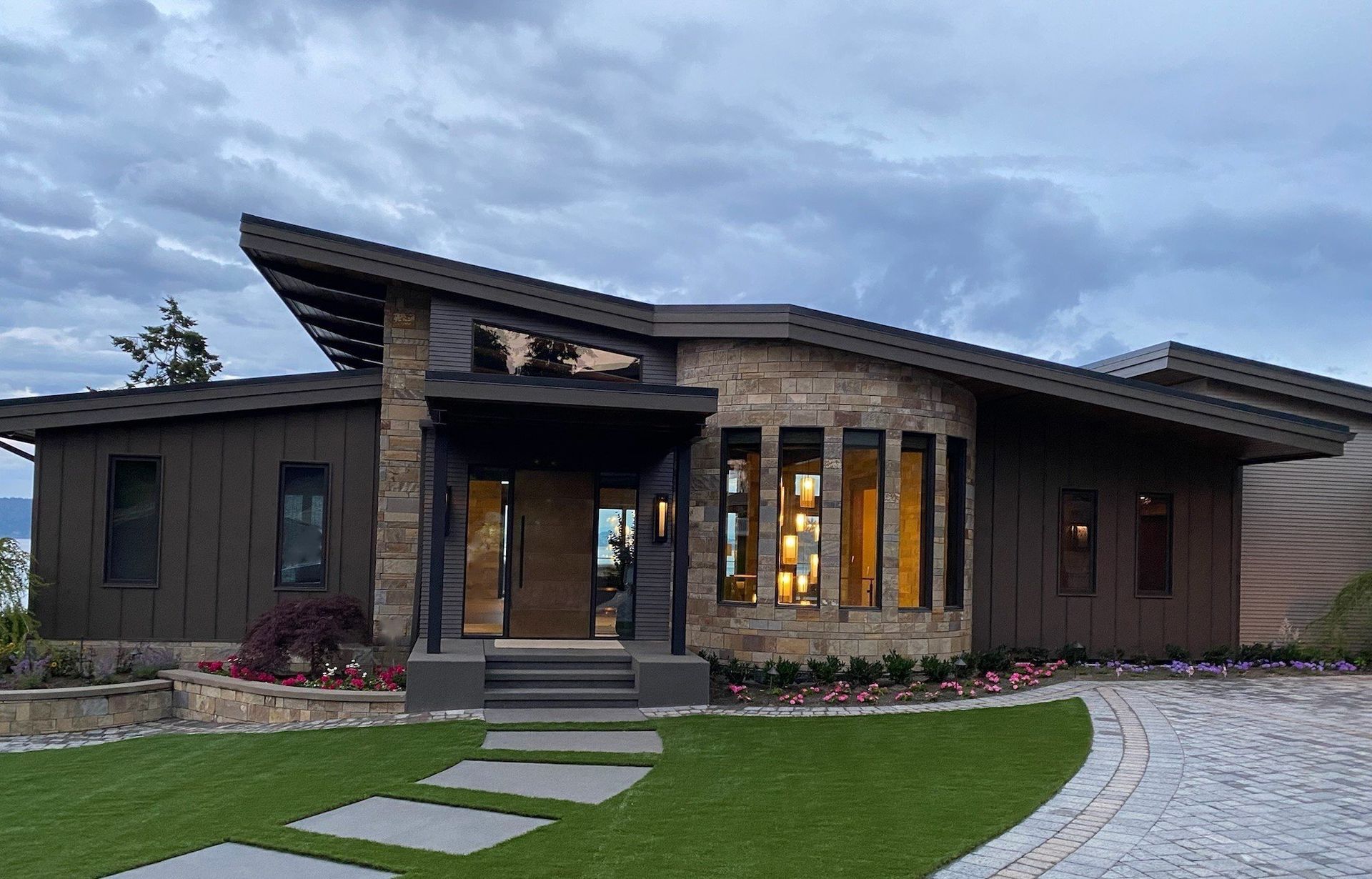 A large house with a stone walkway leading to it.