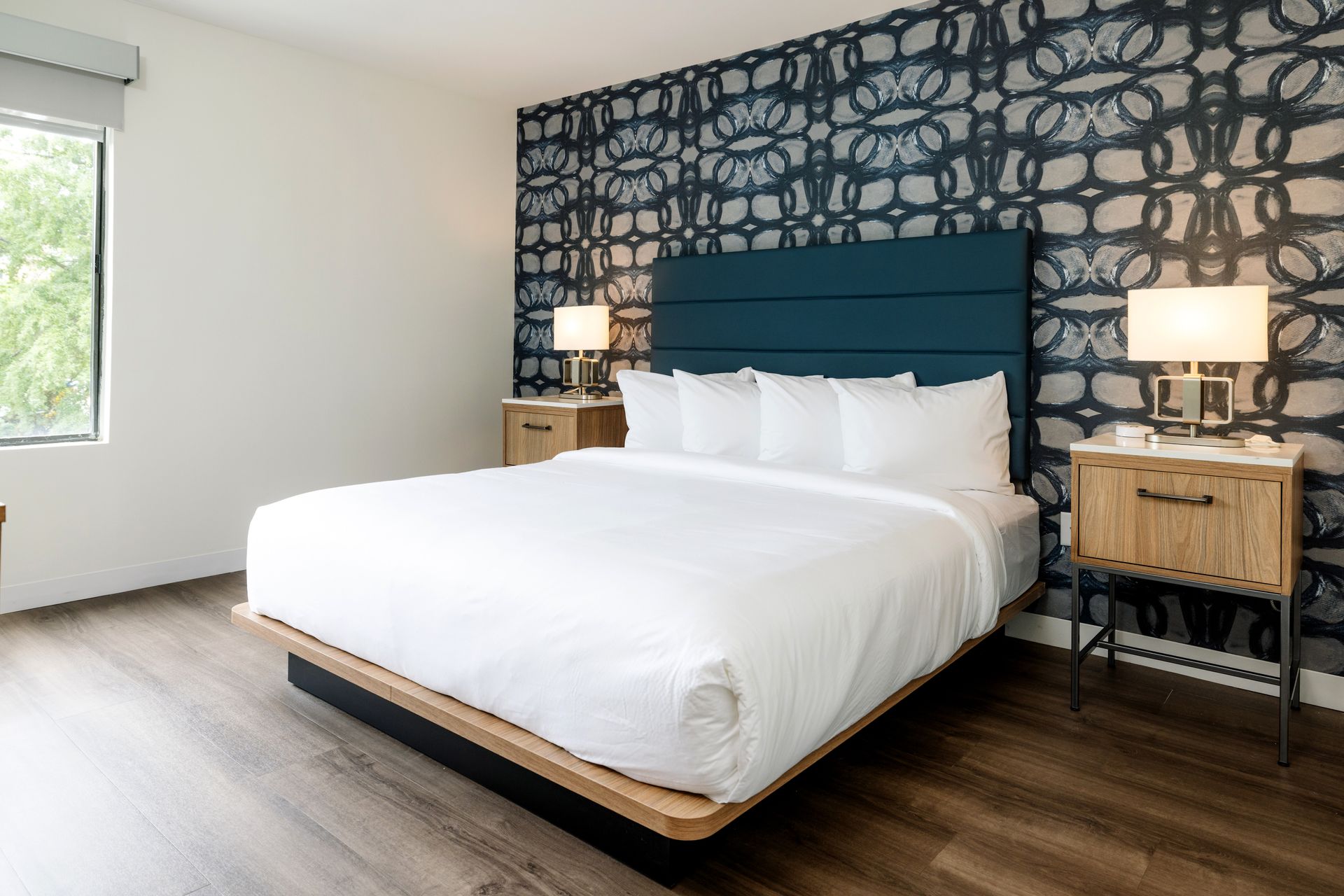 A hotel room with a king size bed and two nightstands.