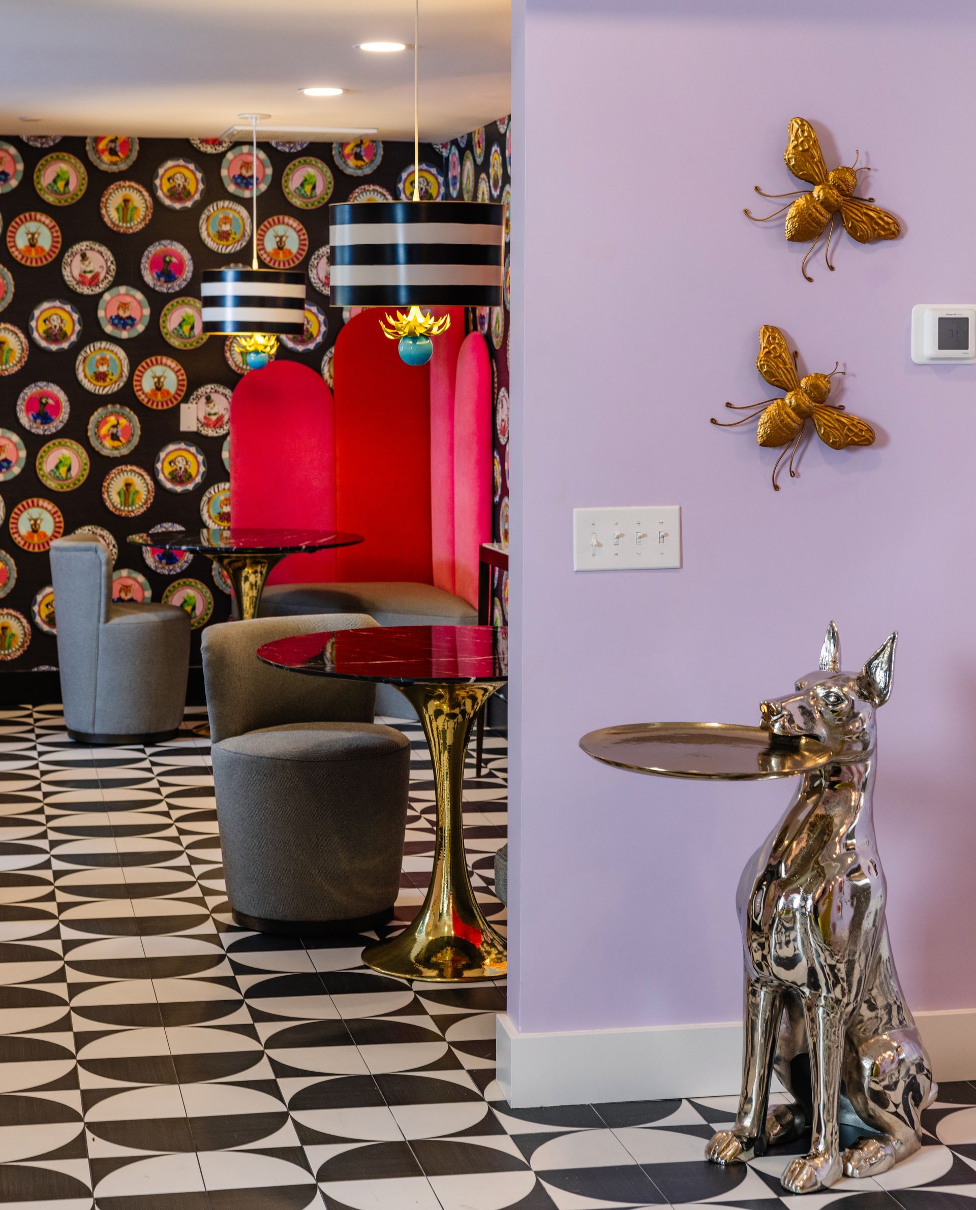 A room with purple walls and black and white tiles