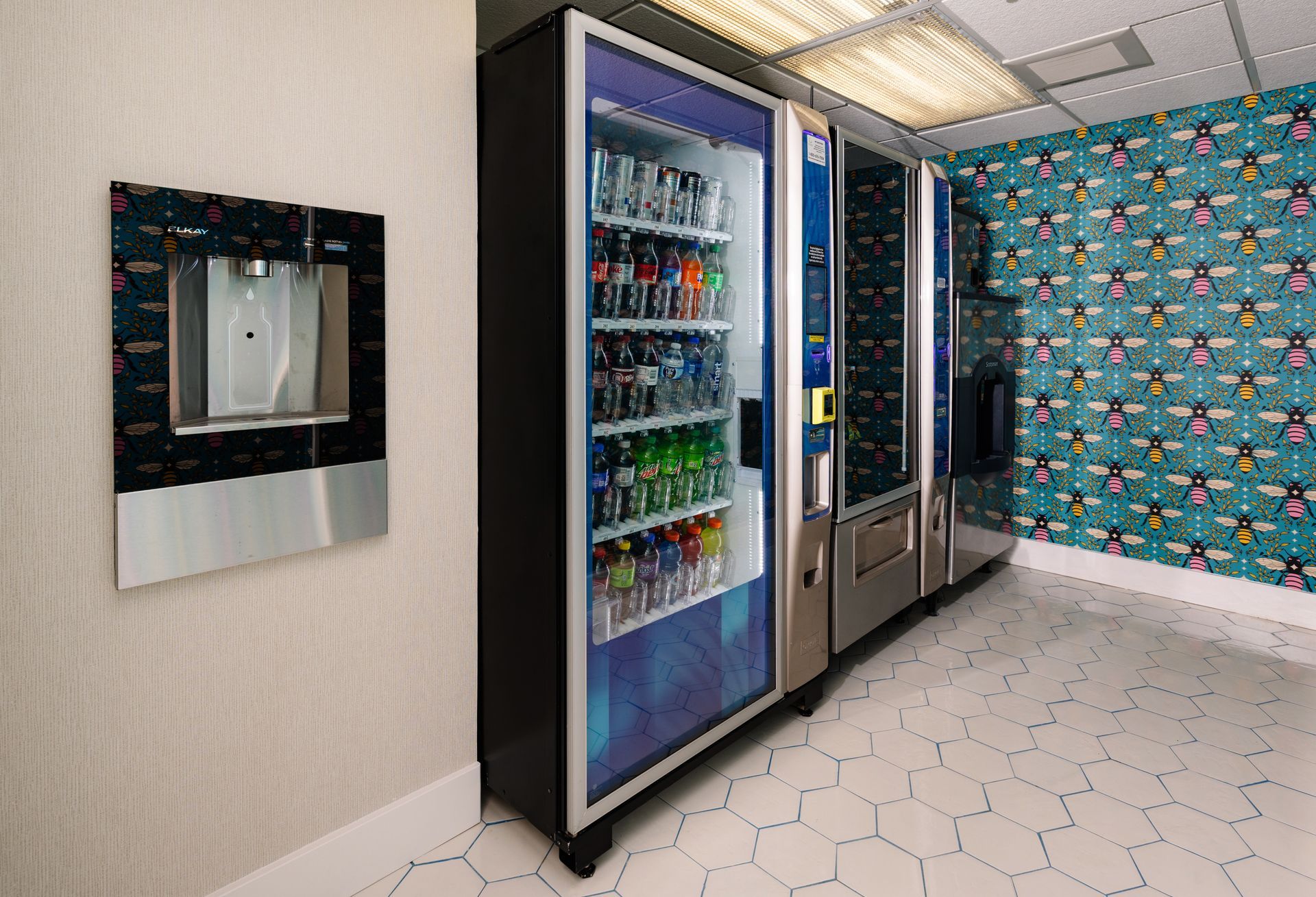 A row of vending machines are lined up in a room.