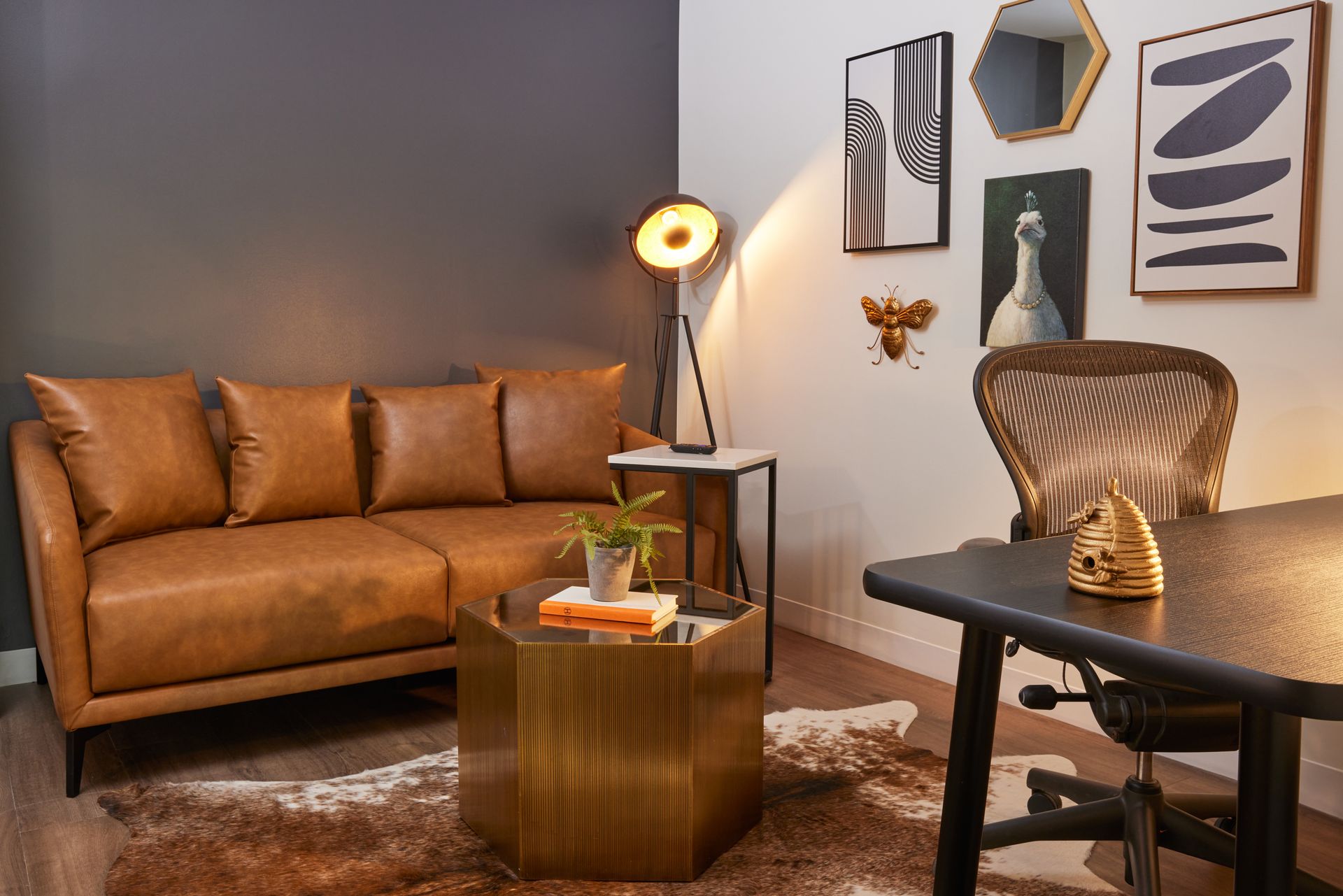 A living room with a couch , table , chair and lamp.