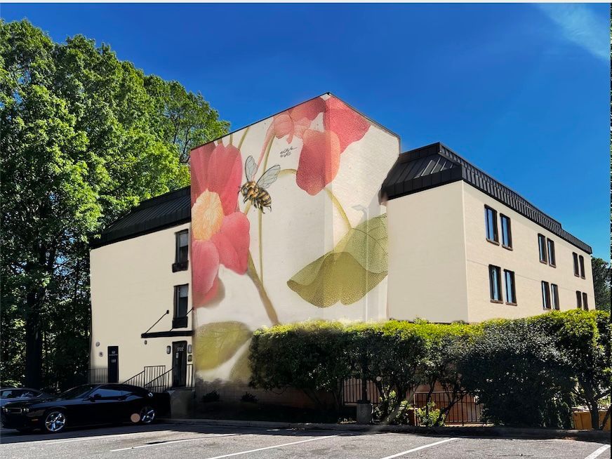 A building with a large mural of flowers on the side