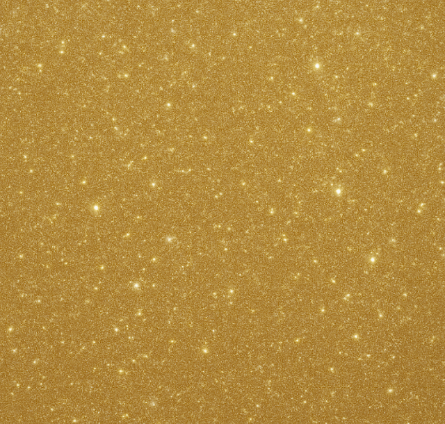Gold glitter background with small, bright specks.