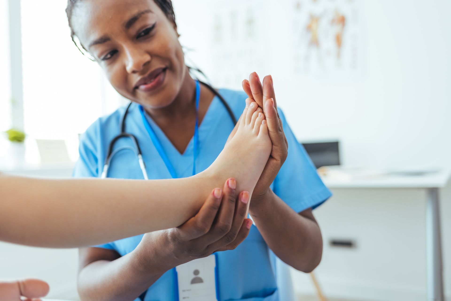 A nurse is examining a patient 's foot in a hospital.