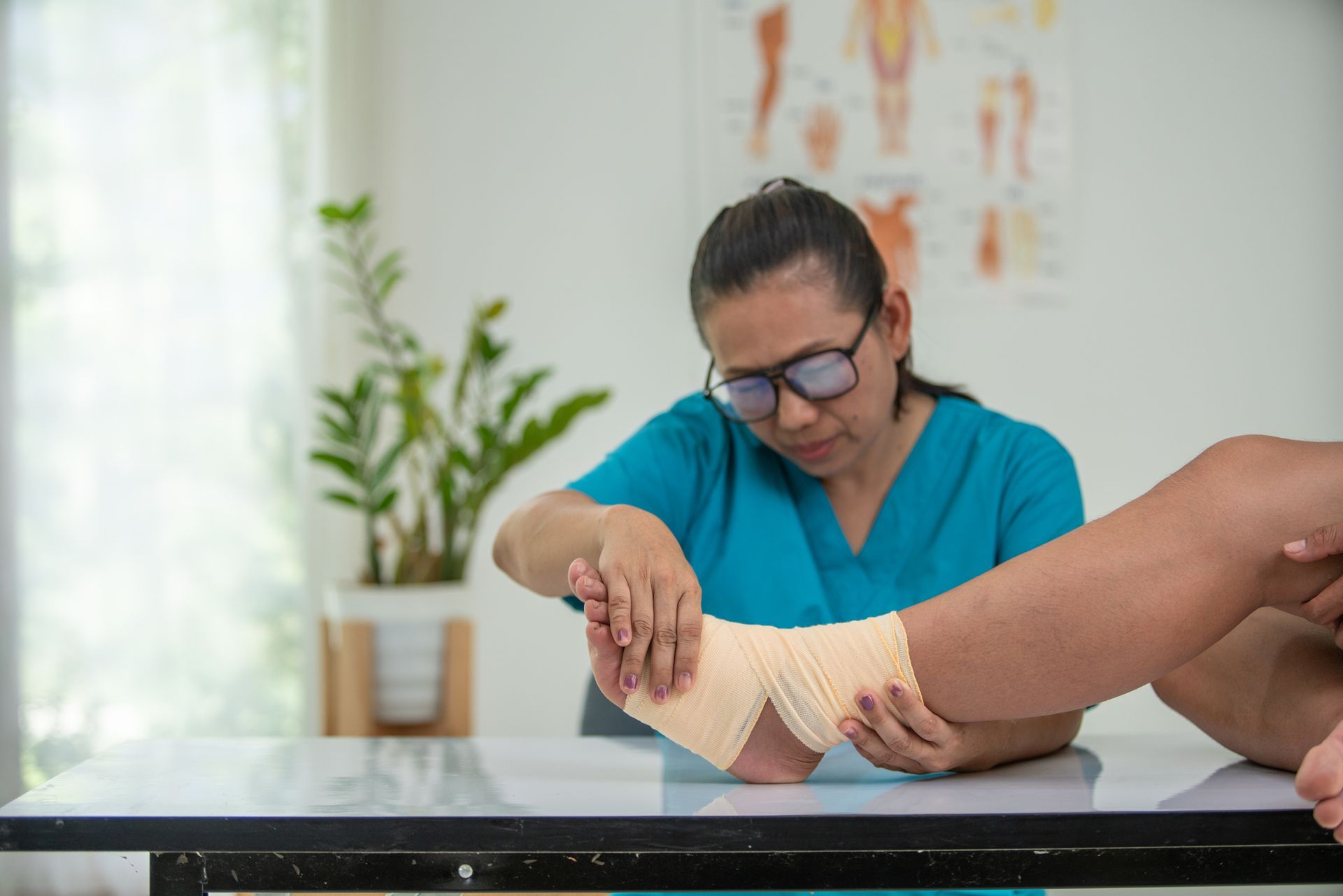 A nurse is putting a bandage on a patient 's foot.
