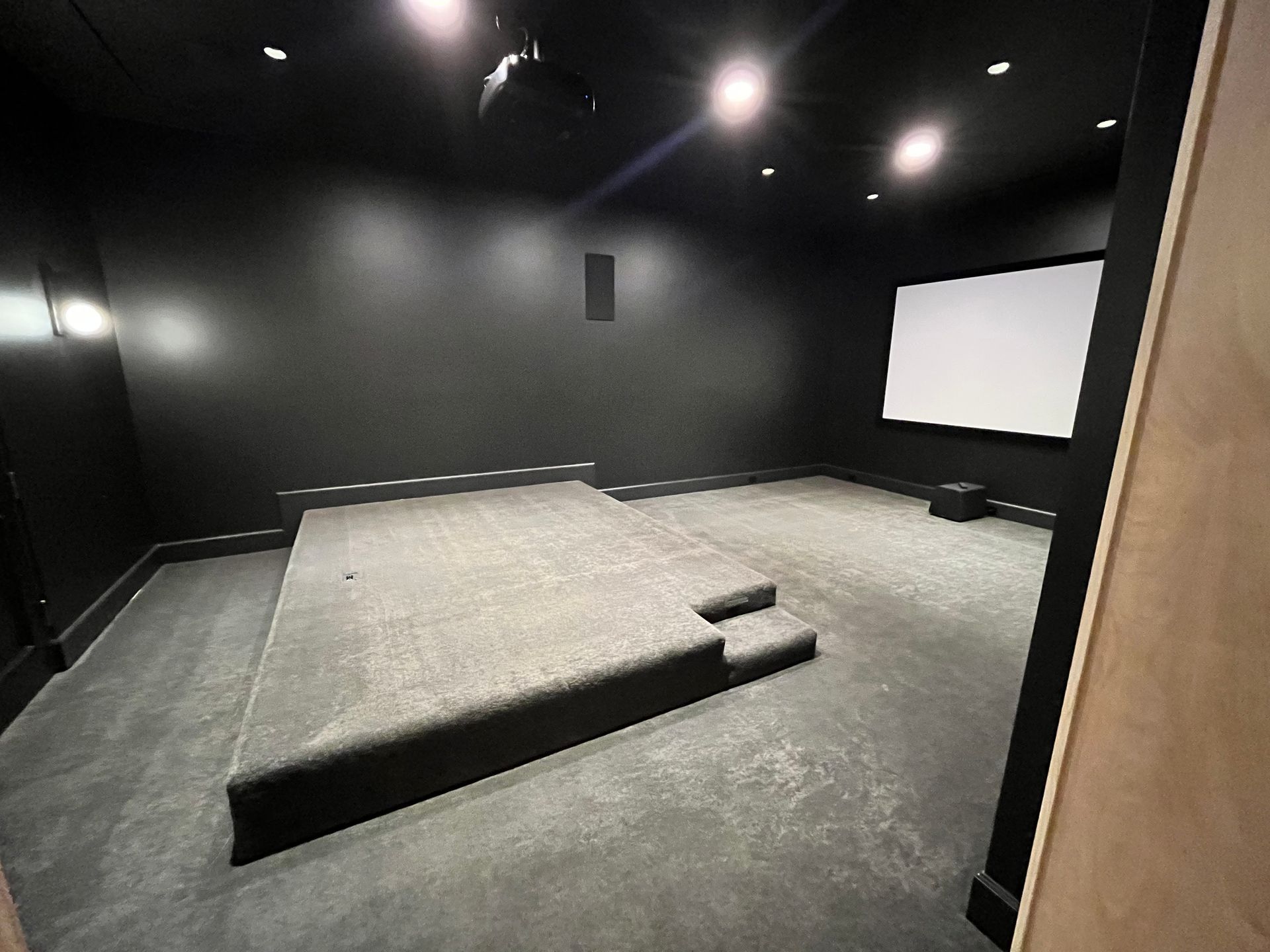 An empty home theater with a large screen