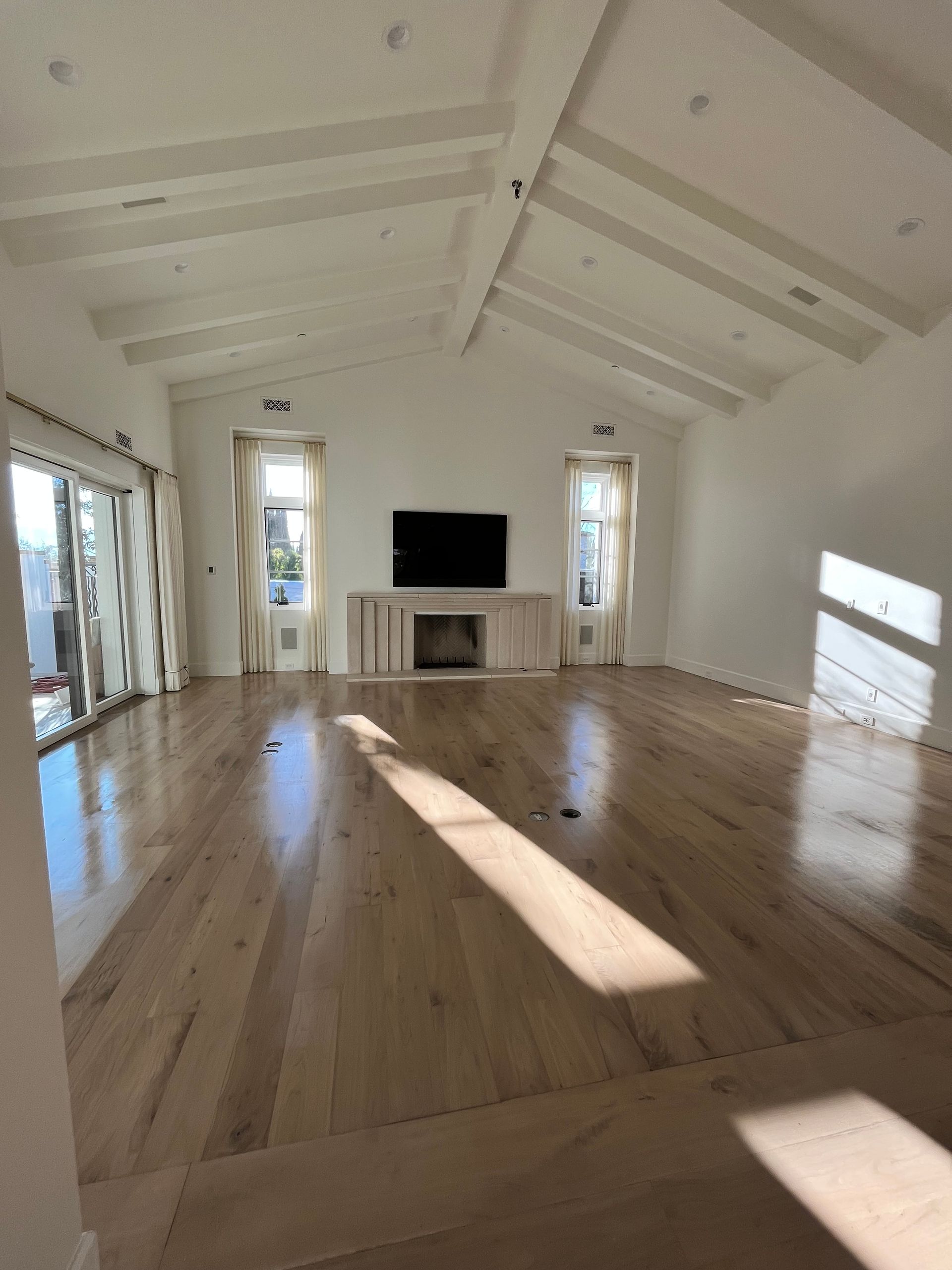 A living room with hardwood floors and a flat screen tv