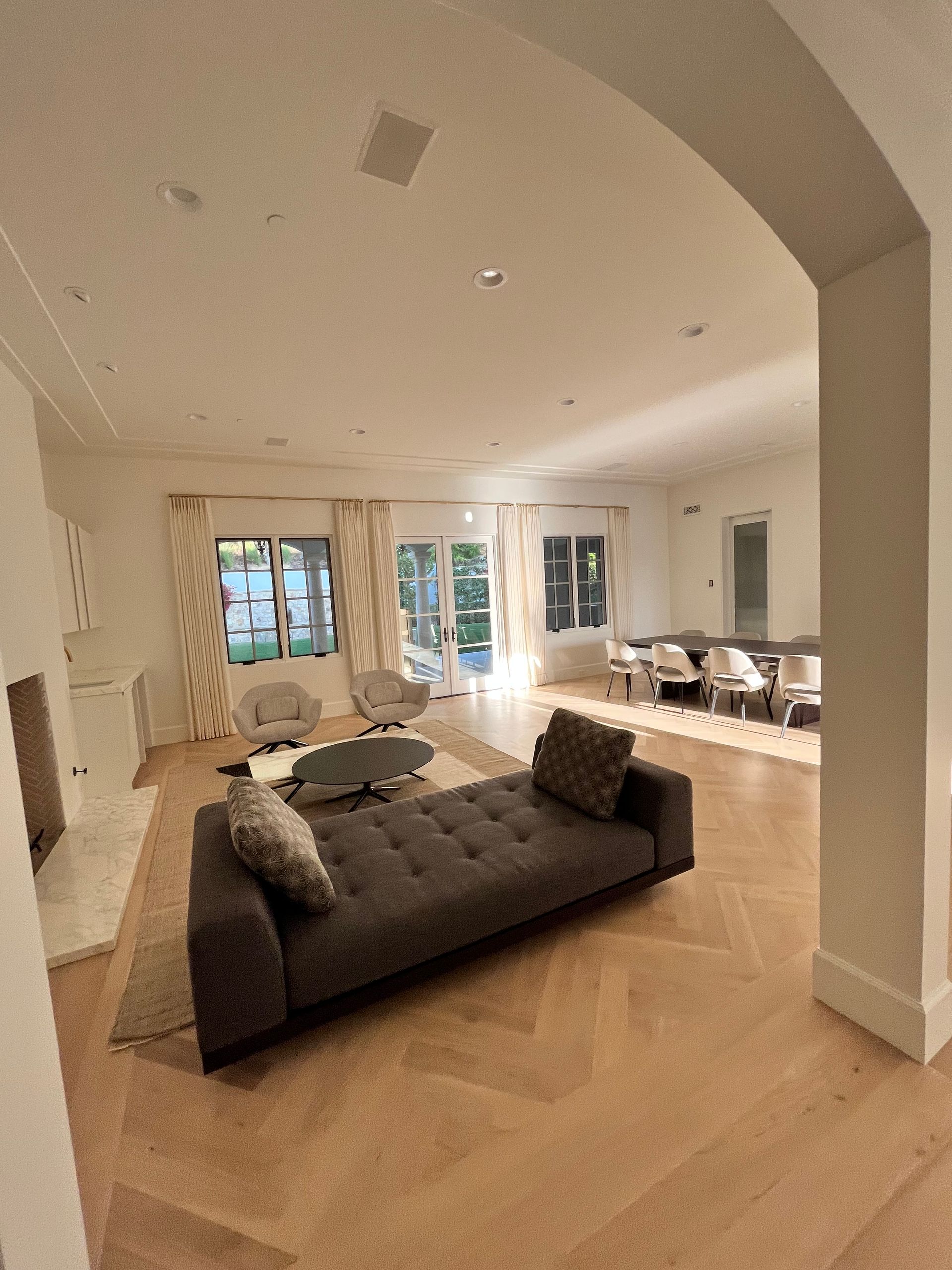 A living room with a couch , chairs , and a fireplace.