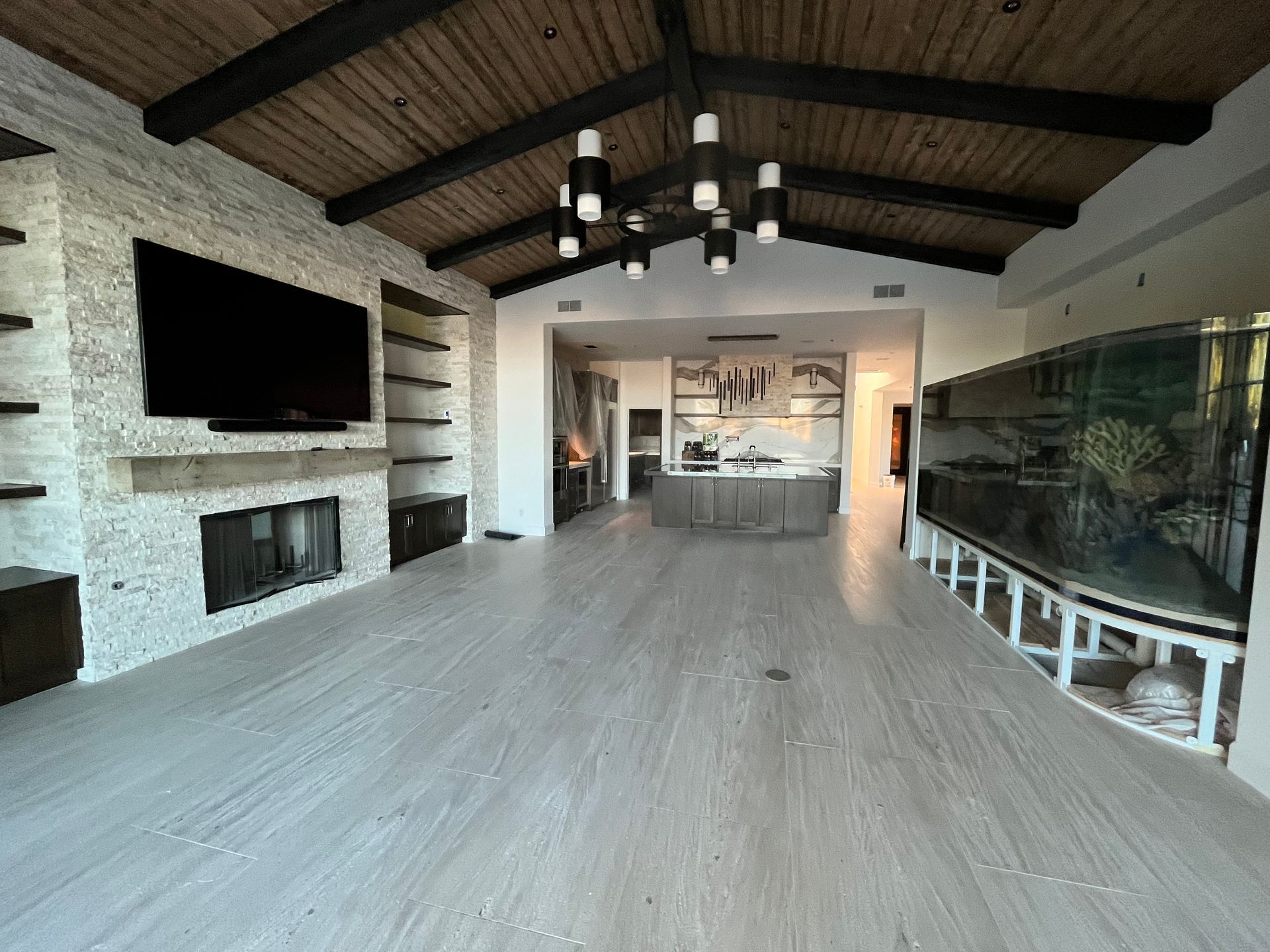 There is a large aquarium in the middle of the living room.