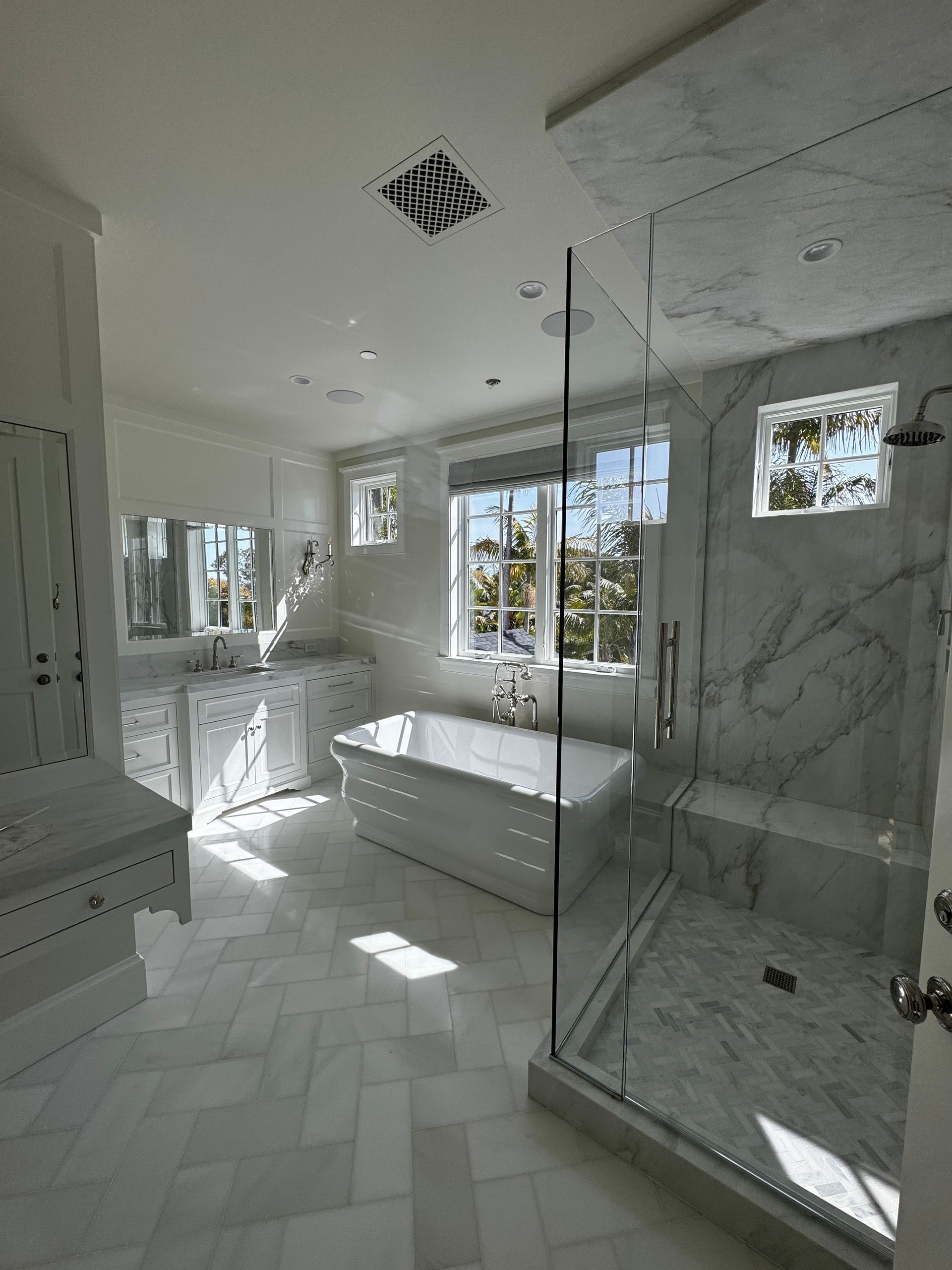 A bathroom with a bathtub and a walk in shower.