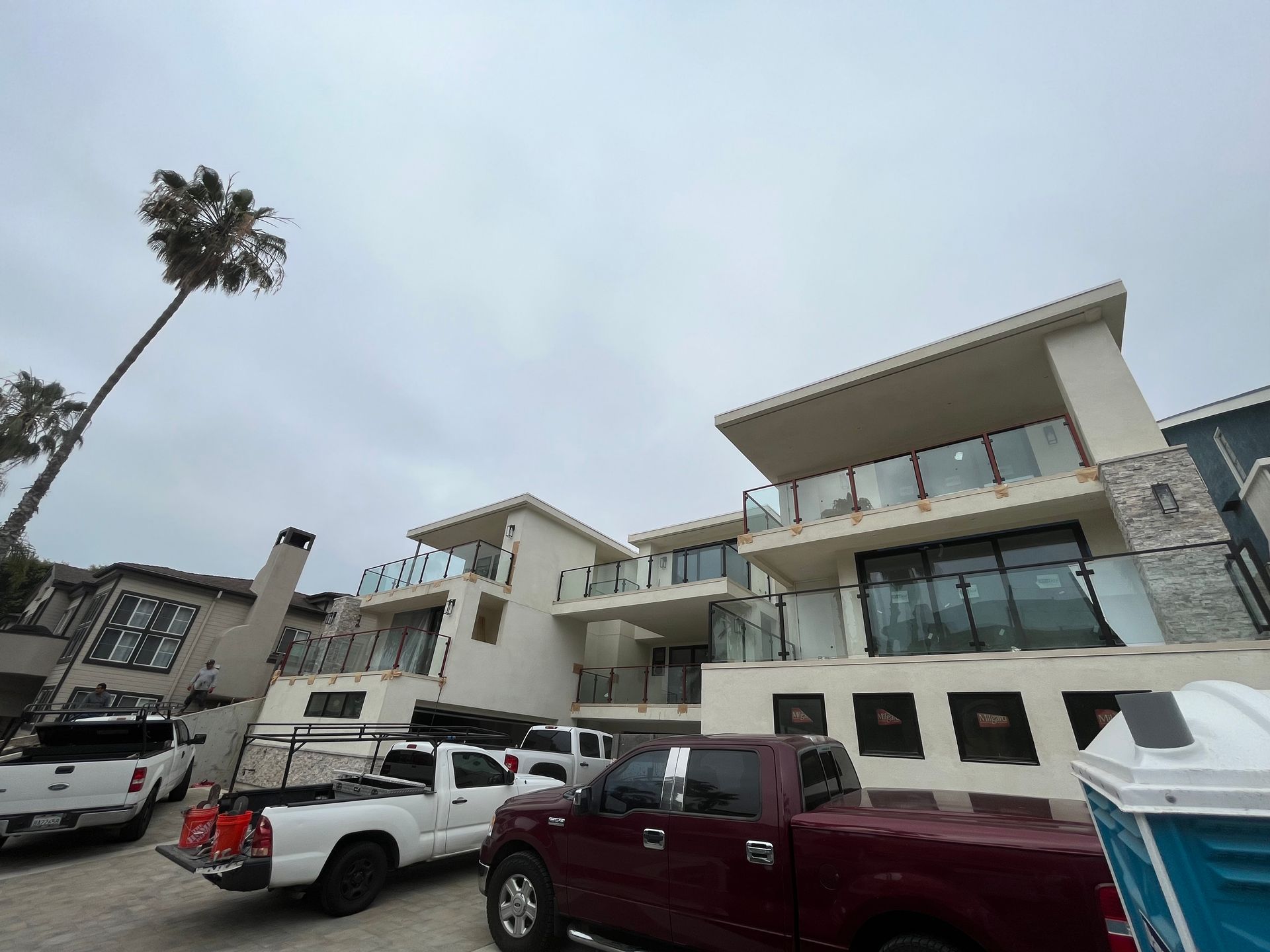 A red truck is parked in front of a building.