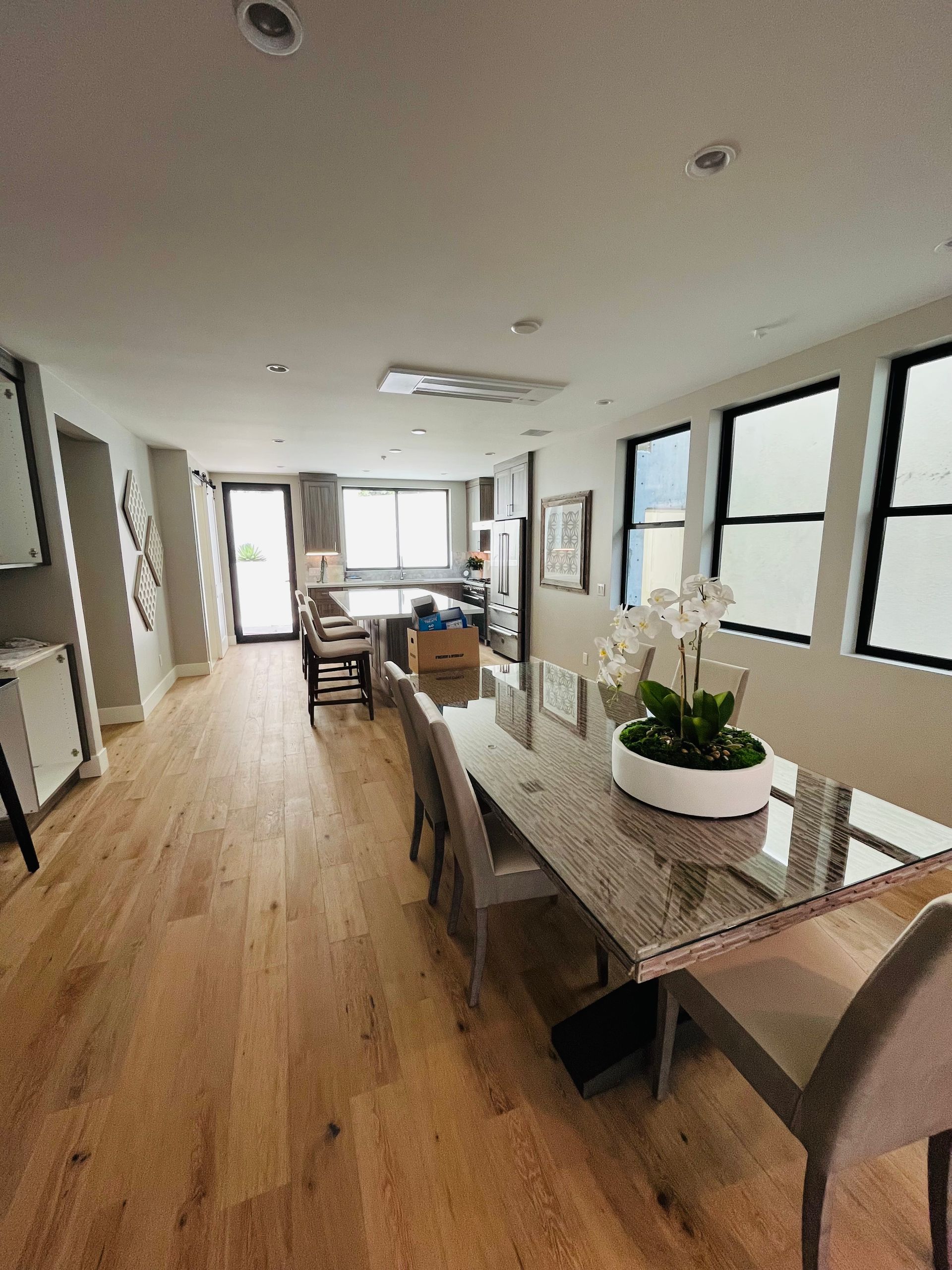 There is a dining table and chairs in the middle of the room.