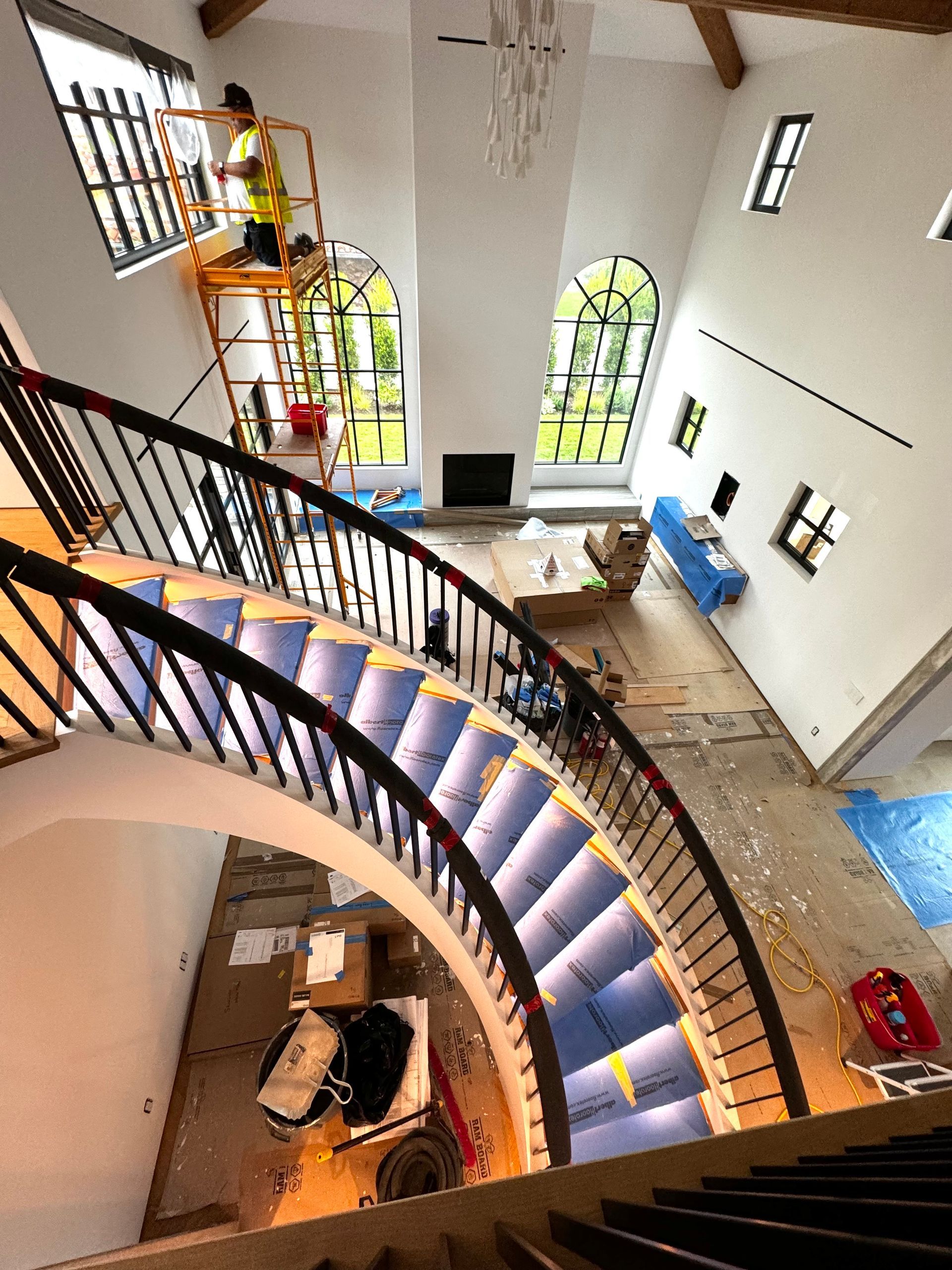 An aerial view of a spiral staircase in a living room.