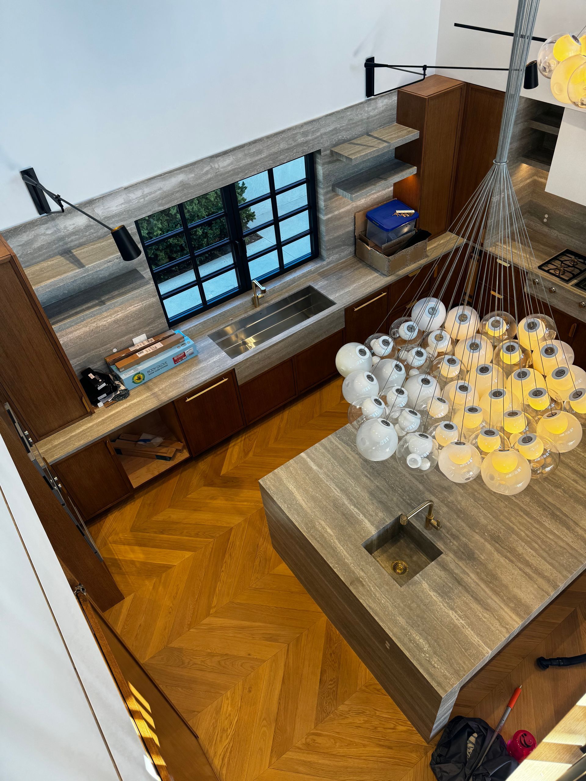 An aerial view of a kitchen with a large island and a sink.