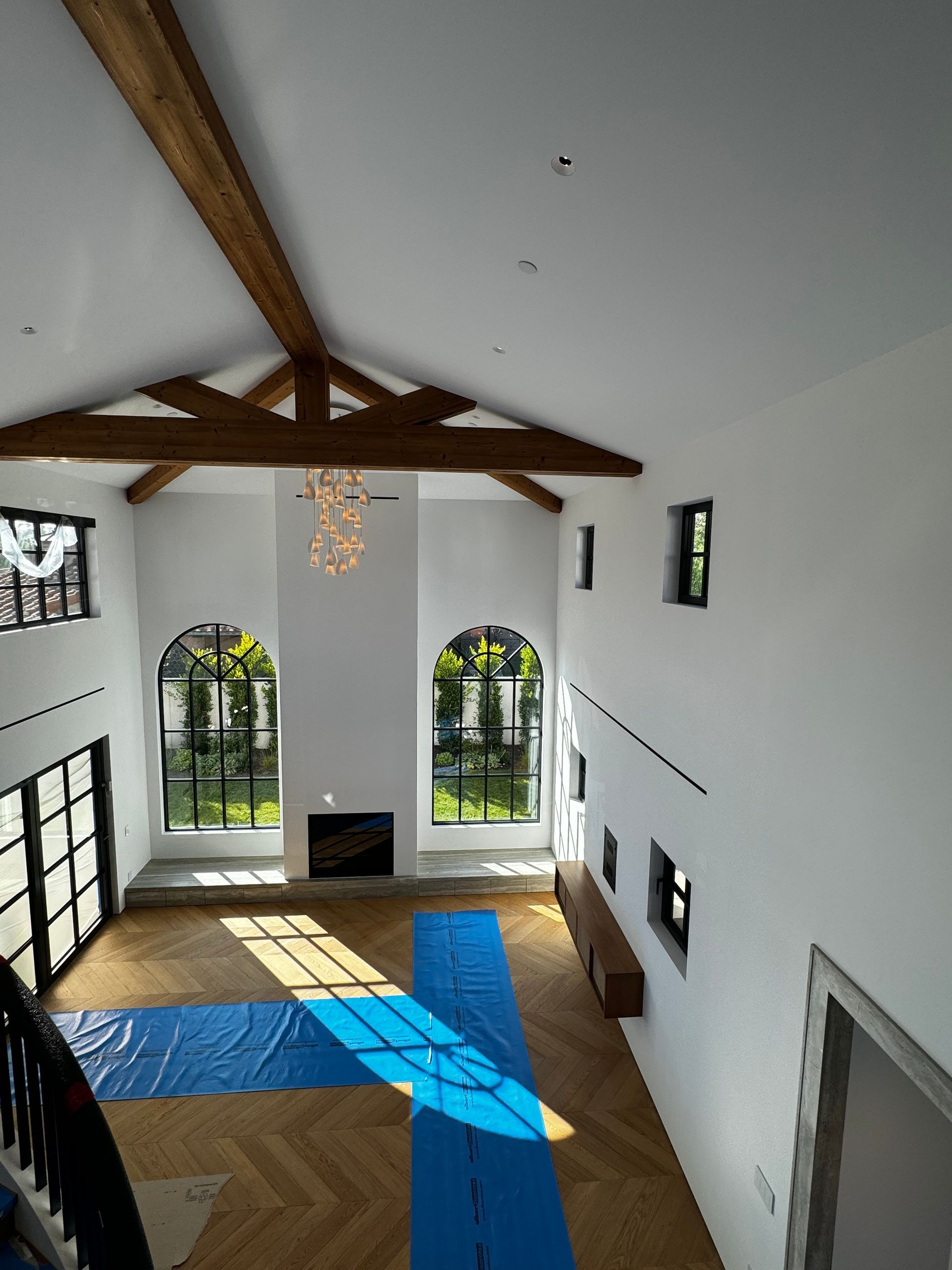 A large room with a lot of windows and a fireplace