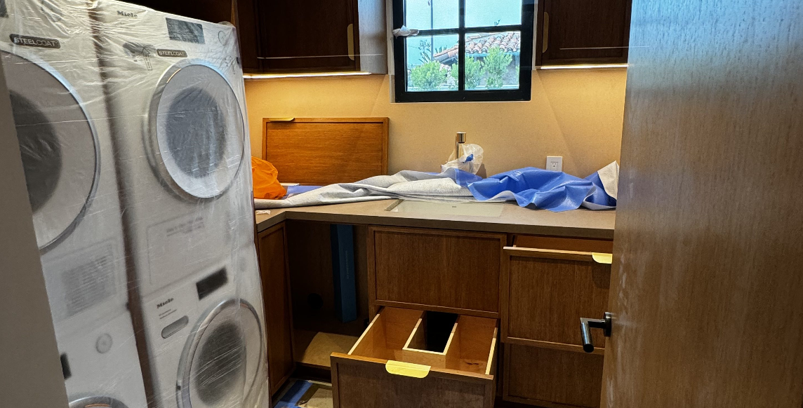 A laundry room with a washer and dryer stacked on top of each other.