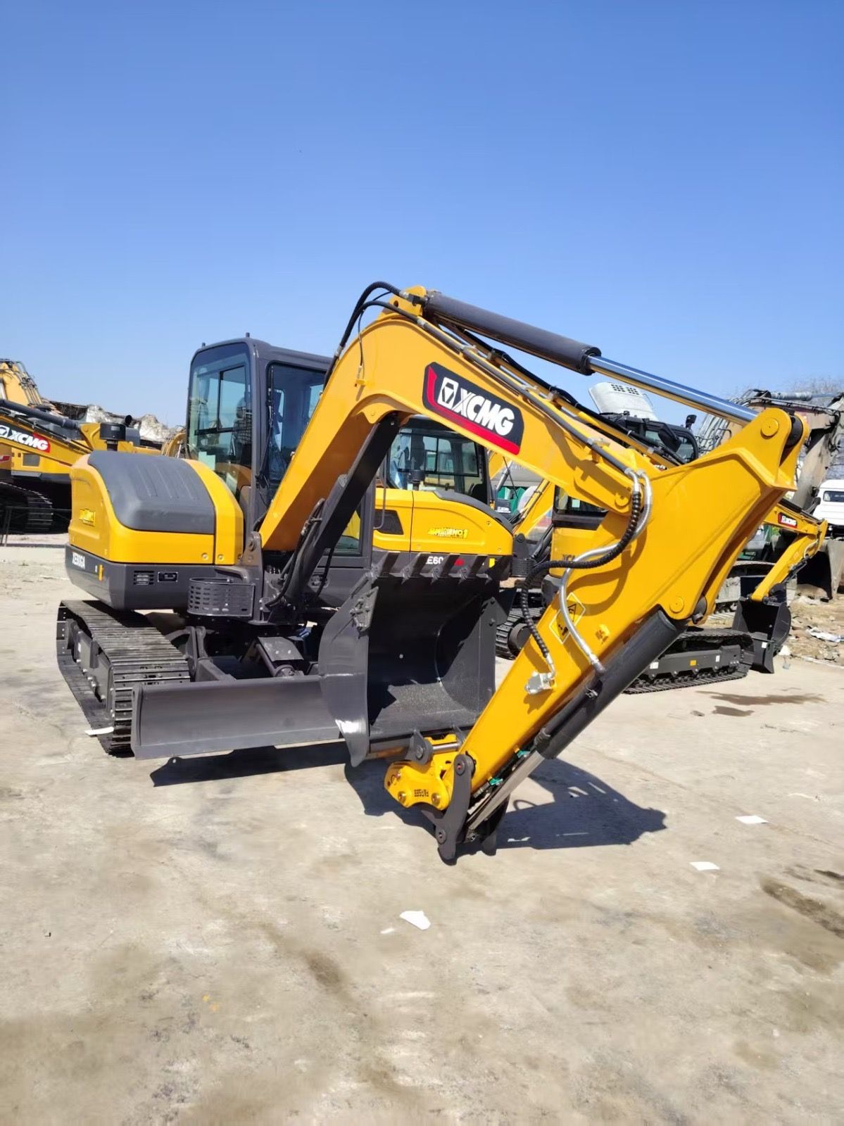 A bulldozer is sitting in the middle of a dirt field.