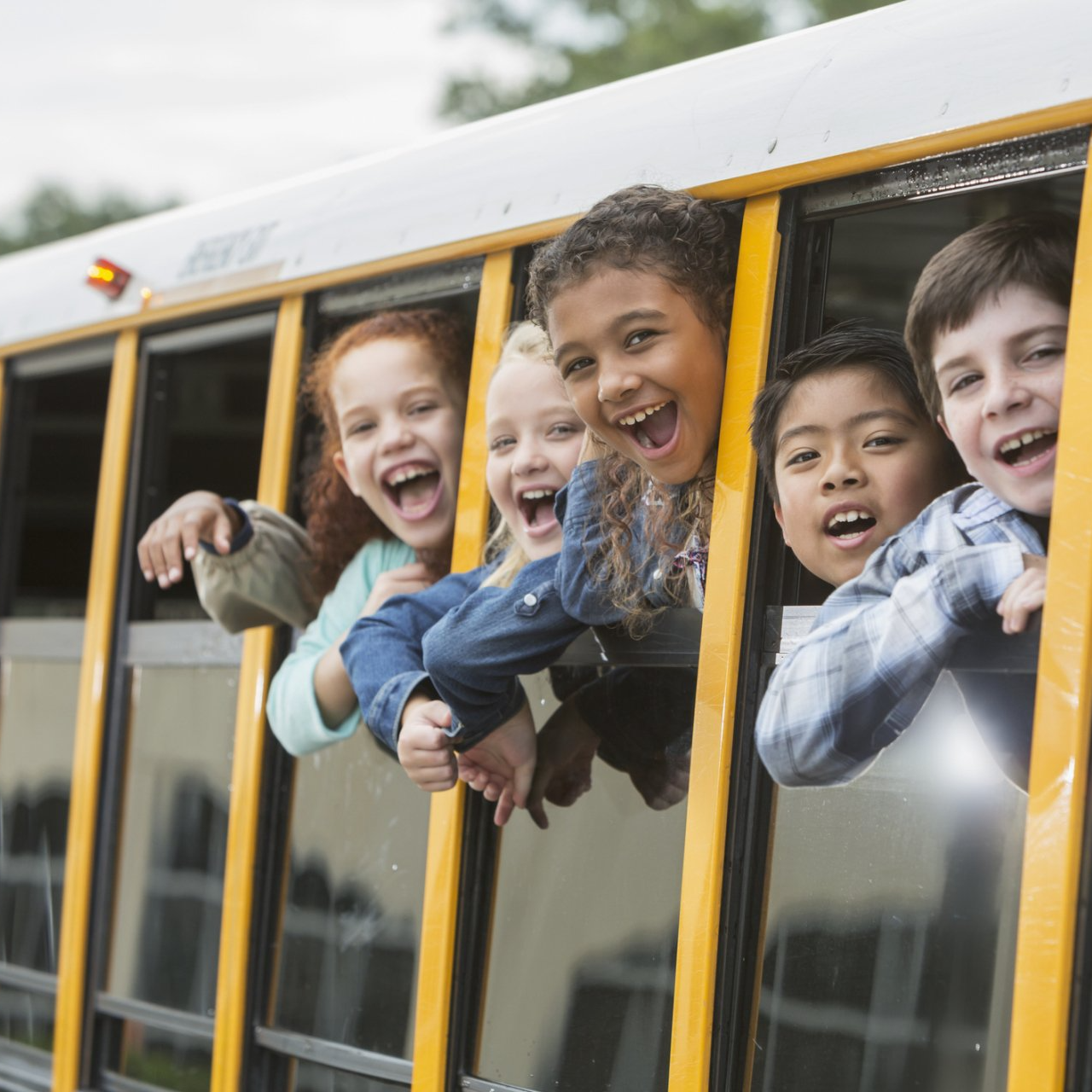 School Children Looking Out Window Of Bus — Raleigh, NC — Pamela's Daycare Center