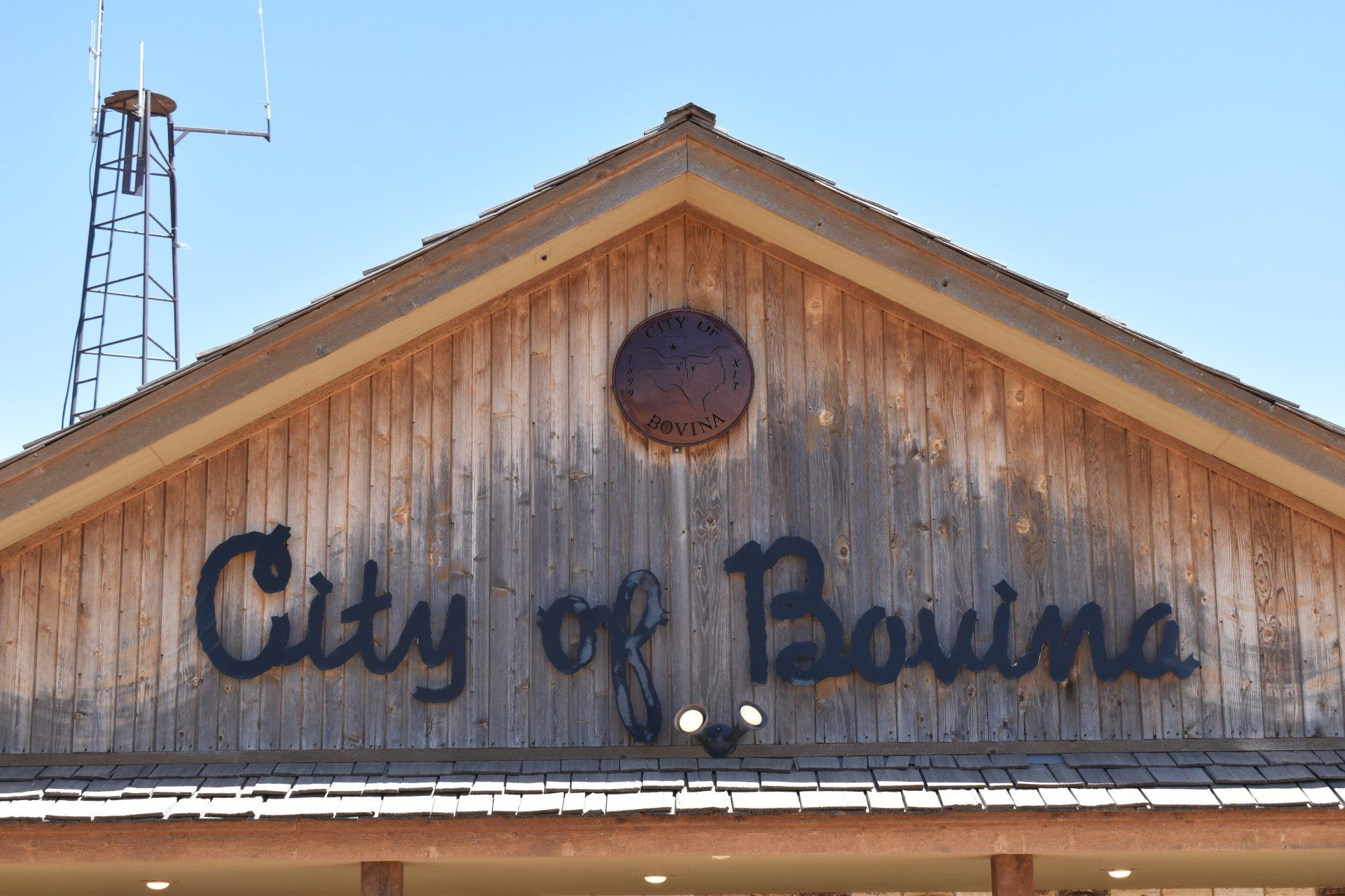 A wooden building with a sign that says city of bovina on it.