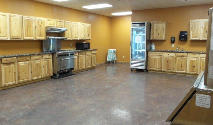 A kitchen with wooden cabinets and stainless steel appliances