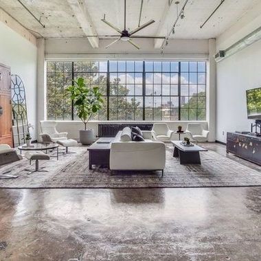 A living room filled with furniture and a large window.