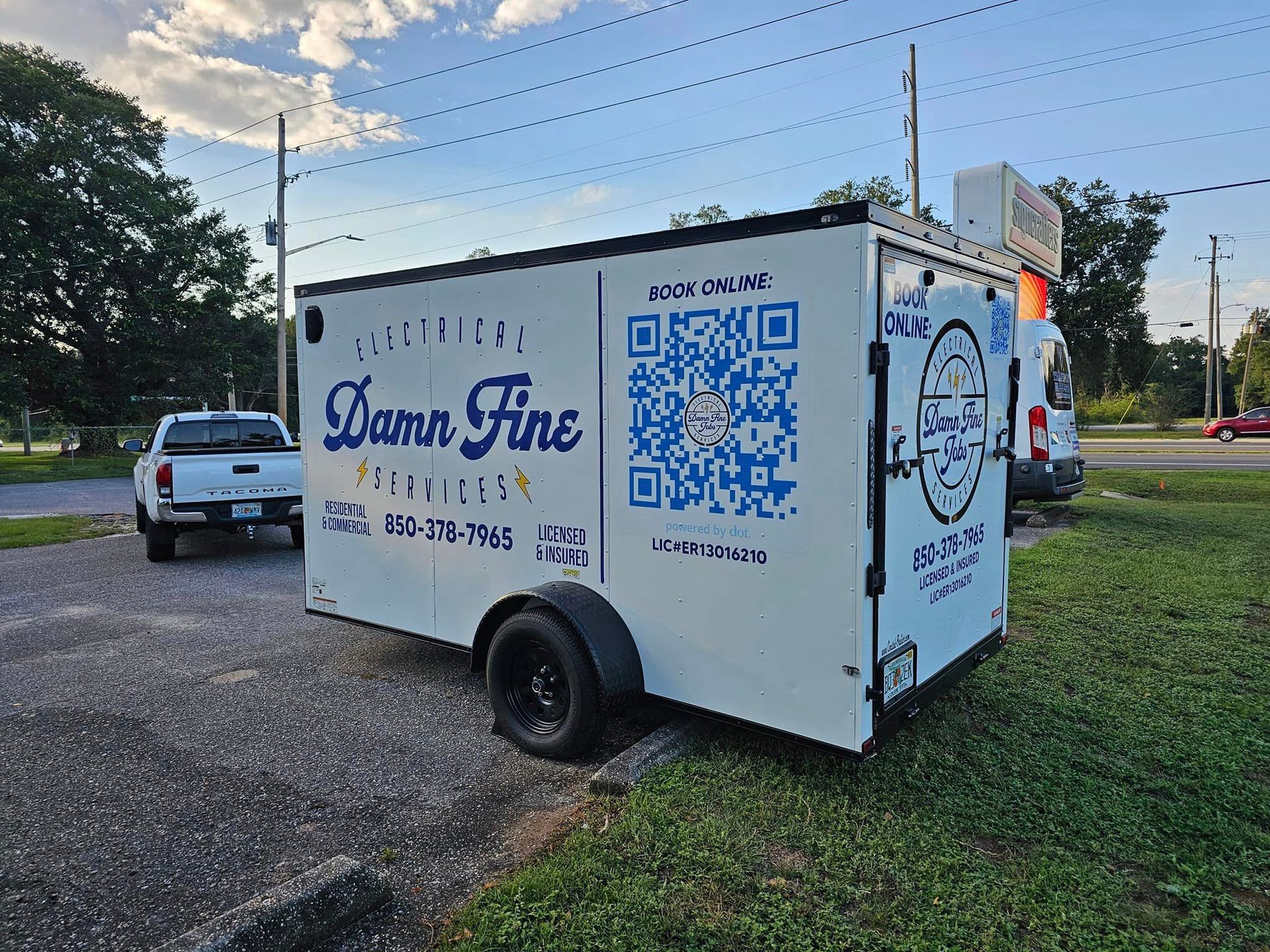 A truck in a parking lot with electrical services decal - Milton, FL - Damn Fine Jobs
