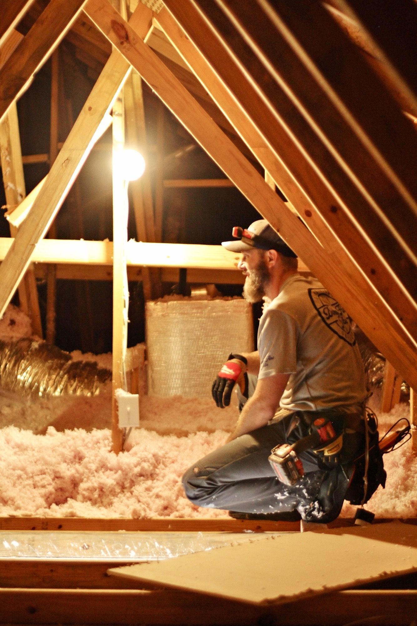 A man is kneeling in the attic of a house - Milton, FL - Damn Fine Jobs