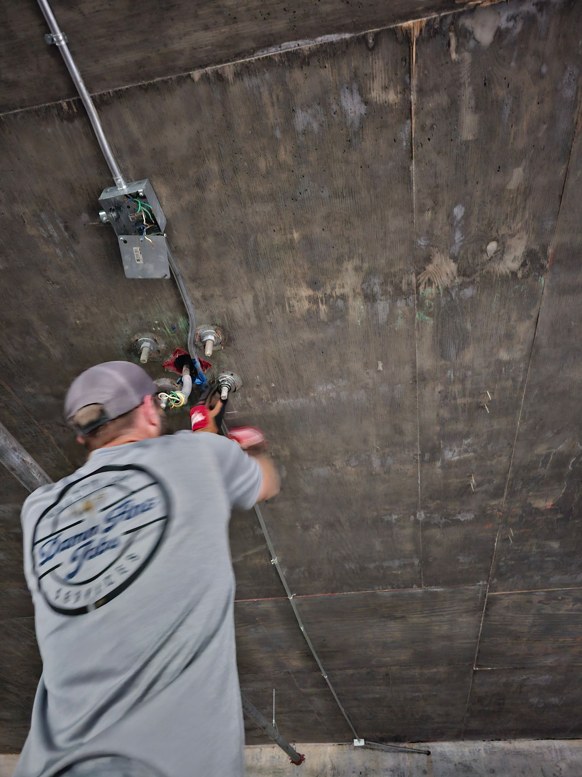 A man in a gray shirt is working on a ceiling - Milton, FL - Damn Fine Jobs