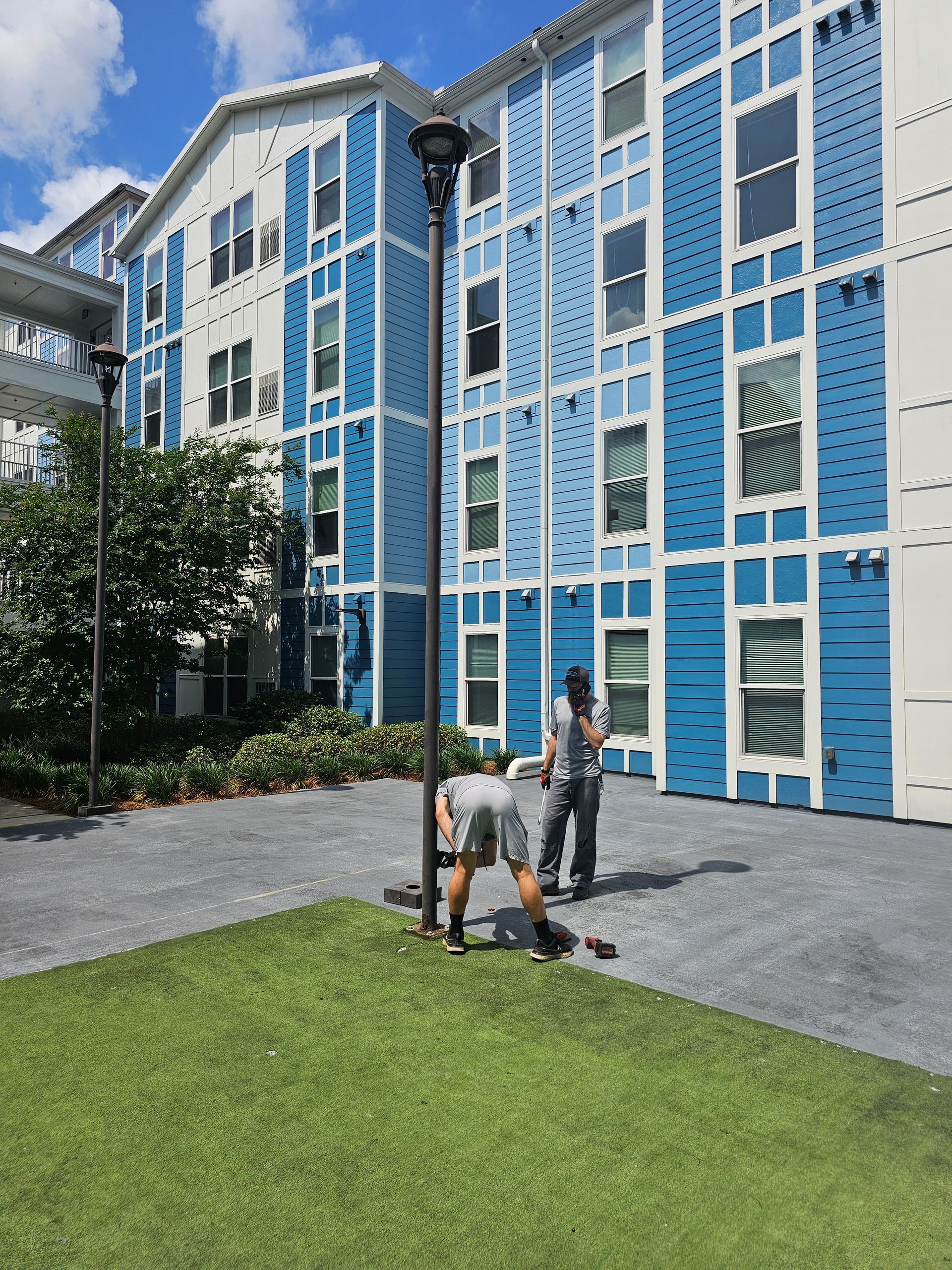 A blue and white building with people standing in front of it - Milton, FL - Damn Fine Jobs