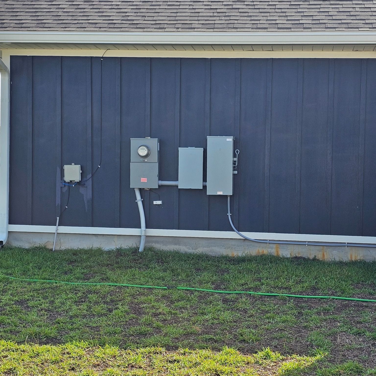 A black house with electrical boxes on the side of it - Milton, FL - Damn Fine Jobs