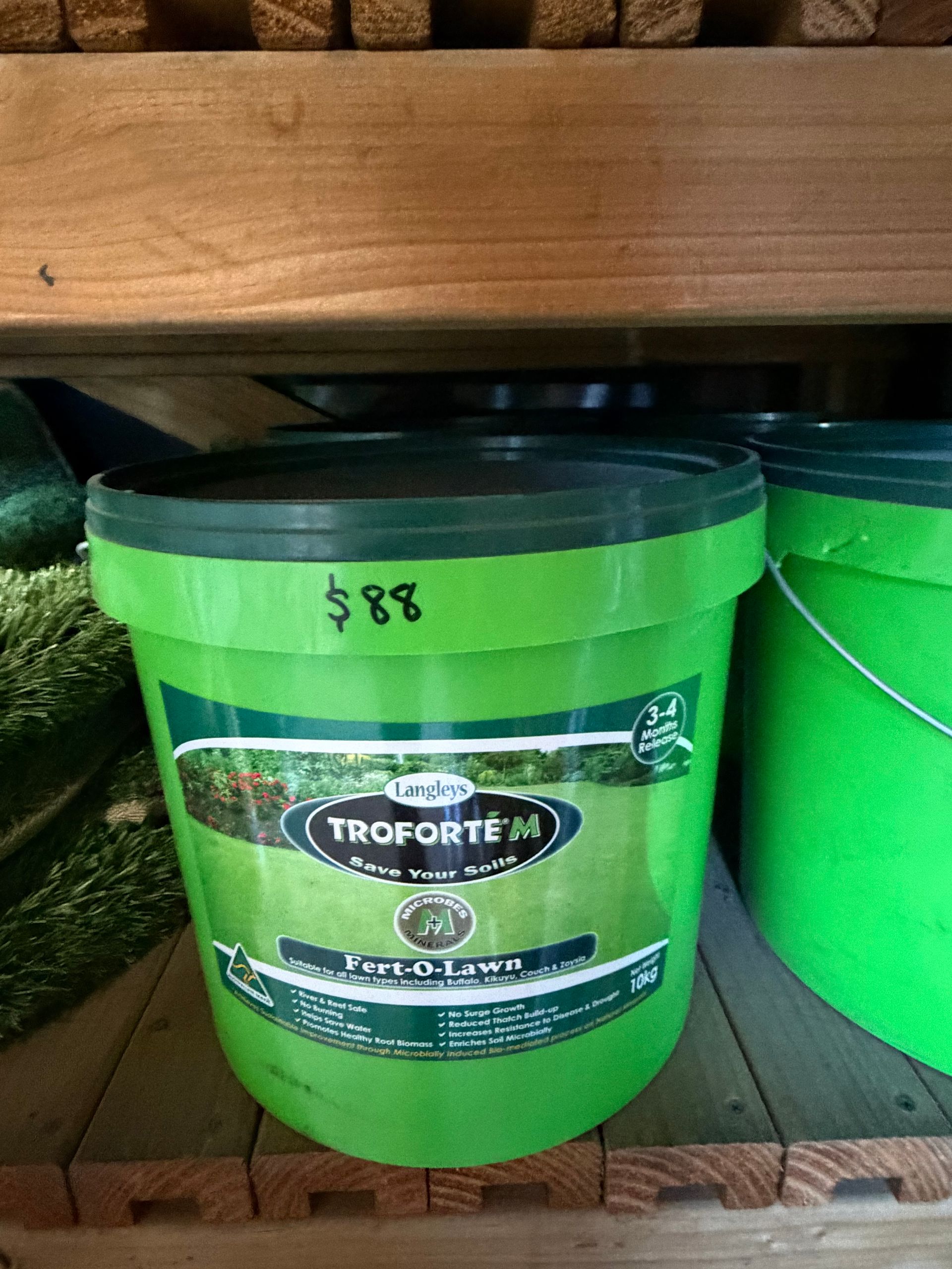 Bright green Troforte bucket on a store shelf with a price tag of $88