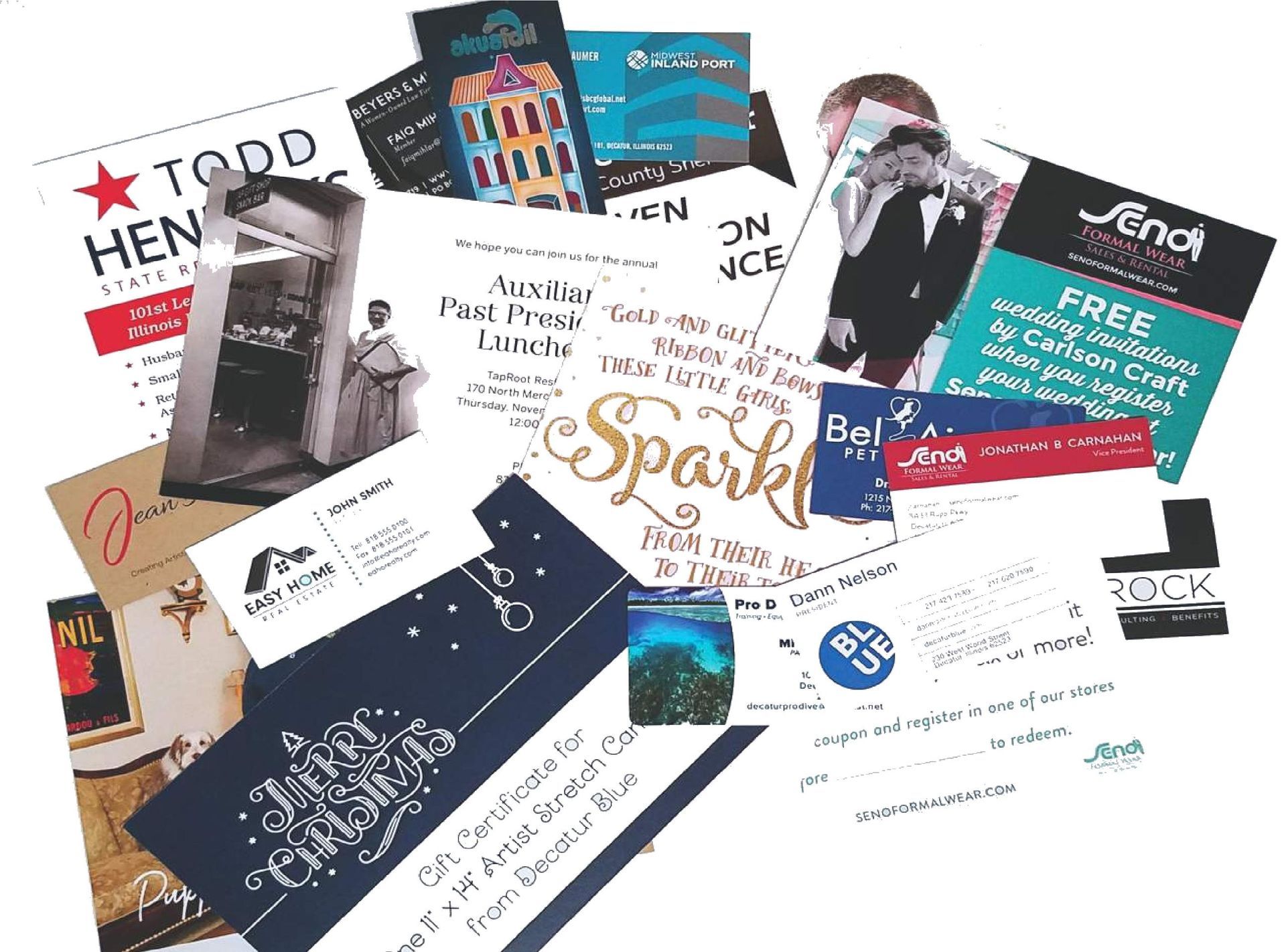 Assorted business cards and marketing flyers scattered on a white background, featuring varied colors and designs