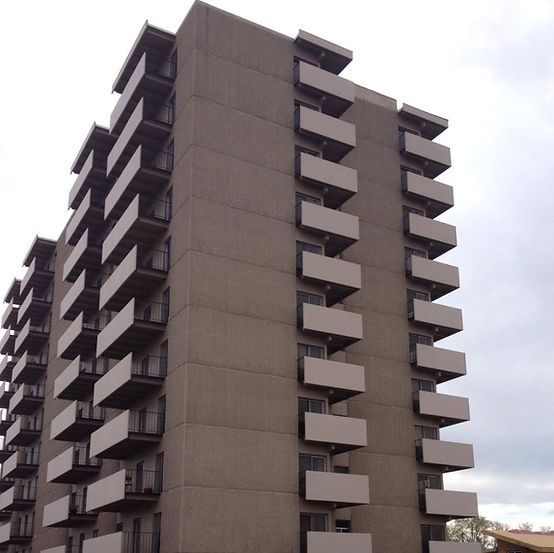 A tall building with a lot of balconies on it