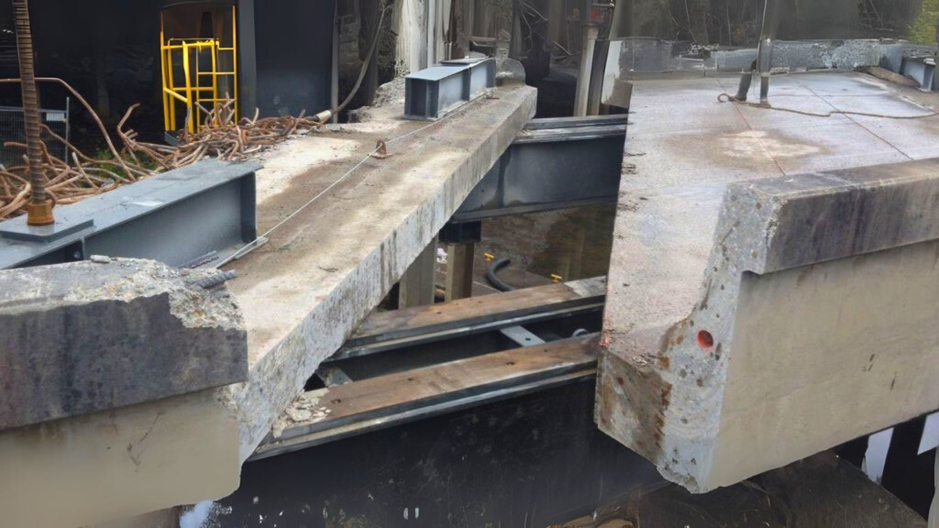 A concrete bridge with a metal frame is being built.