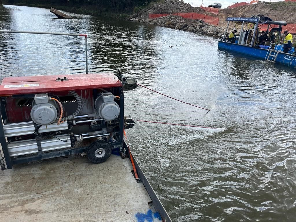 A boat is going down a river next to a generator.