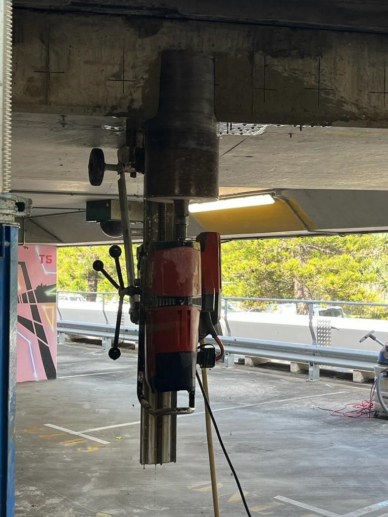 A drill is hanging from the ceiling of a building.