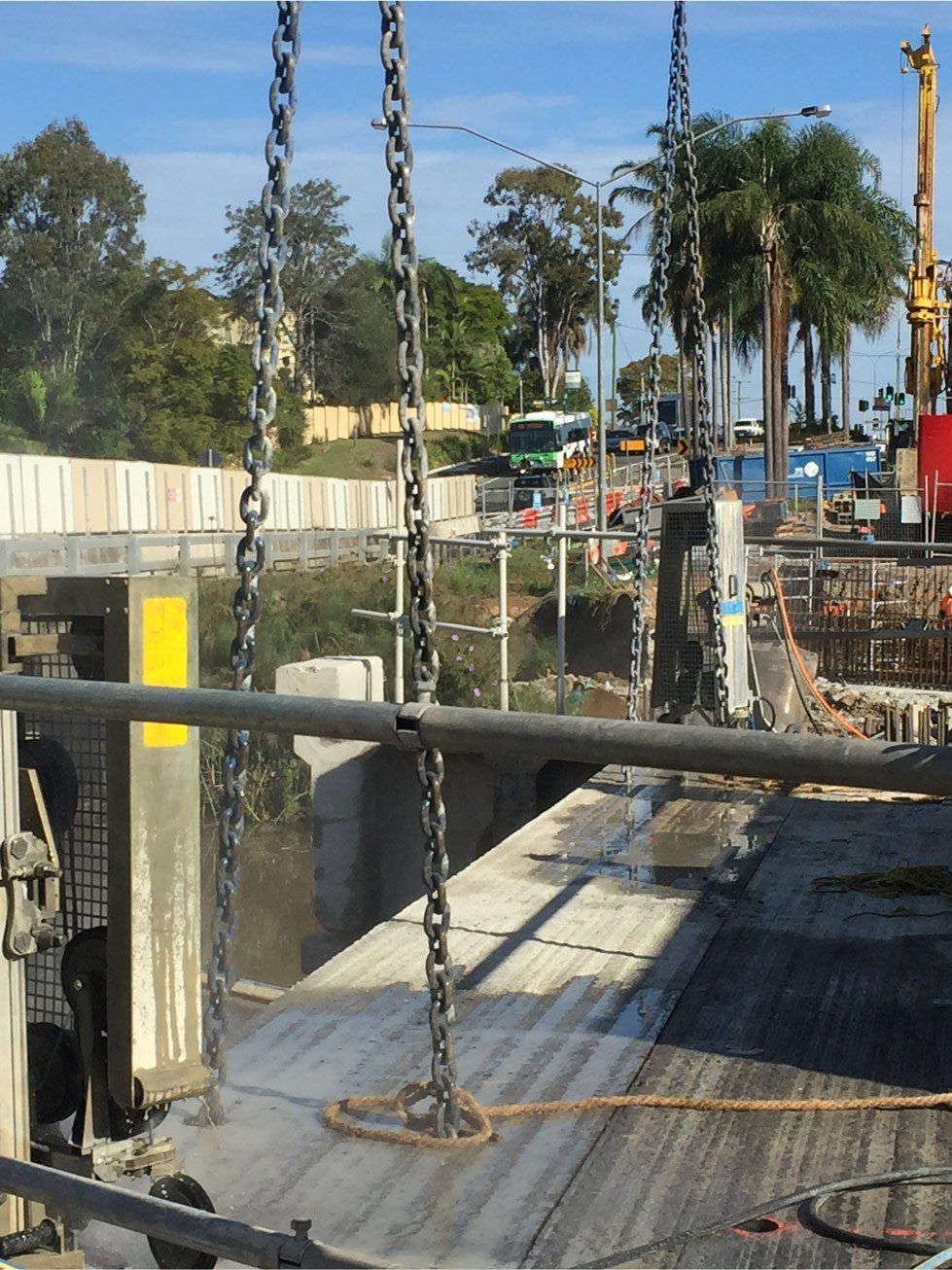 A bridge is being built with chains hanging from it