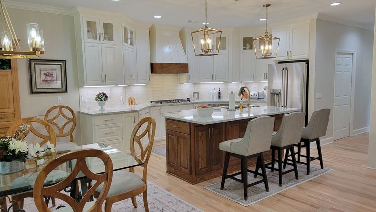 Finished kitchen remodel with warm wood cabinetry and stone countertops