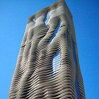A tall building with a blue sky in the background.