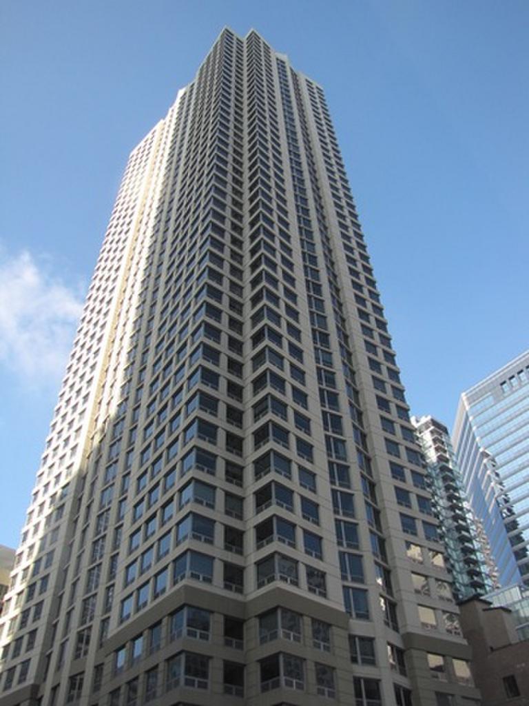 Looking up at a tall building with a blue sky in the background
