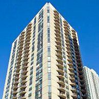 Looking up at a tall building with a blue sky in the background.