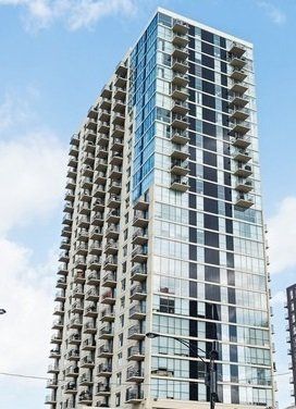 A tall building with a lot of windows and balconies