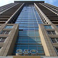 Looking up at a tall building with the number 250 on it.